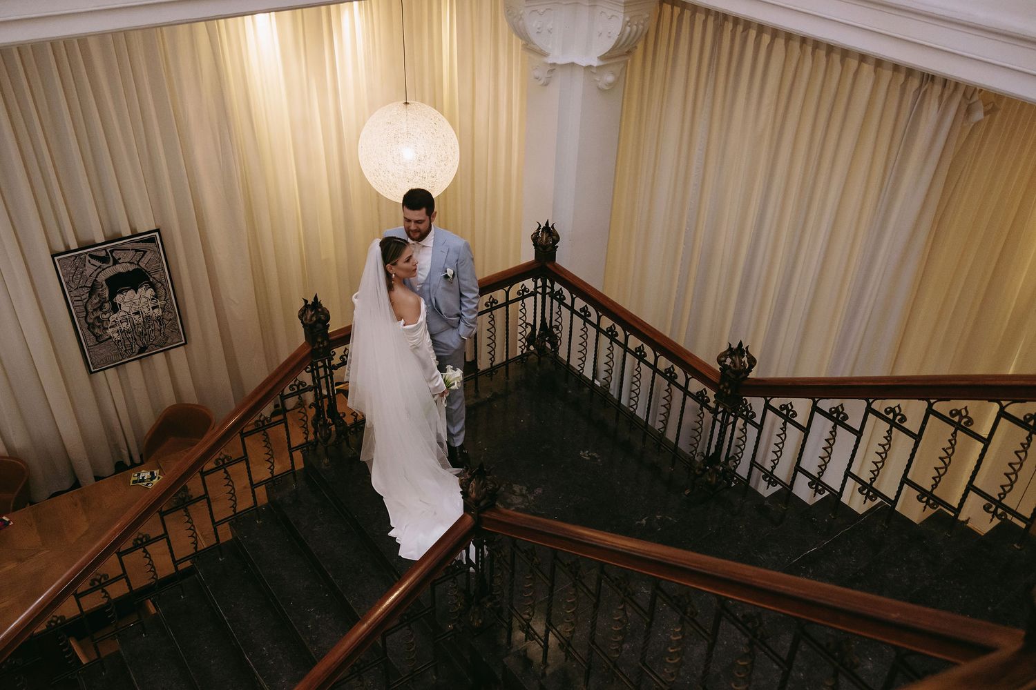 A series of images showing an elegant white-draped staircase with wooden railings.