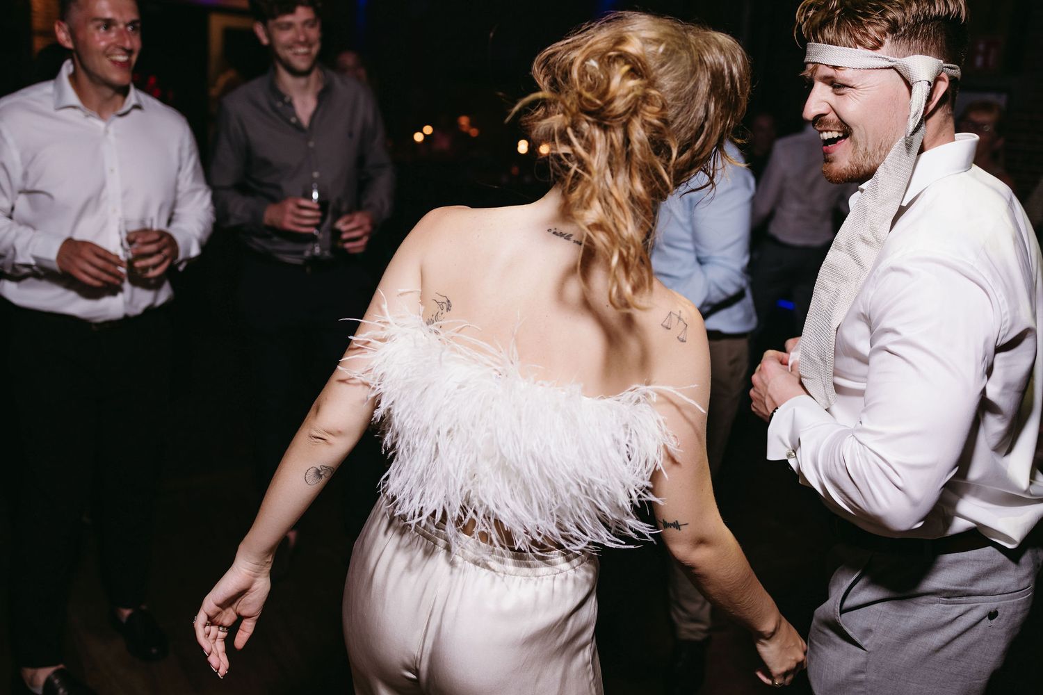 Wedding reception dance floor with people dancing and celebrating.