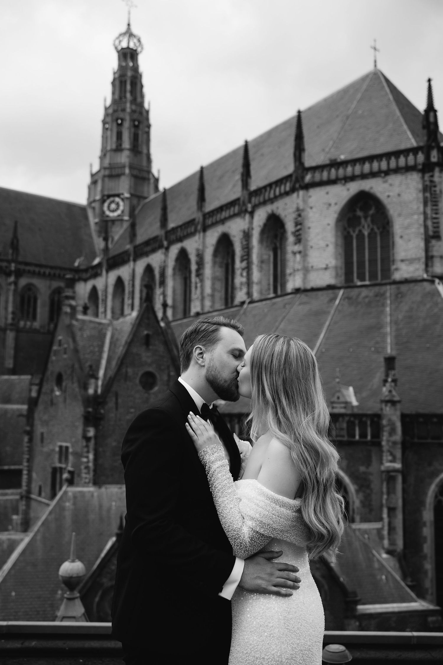 A romantic moment captured against the backdrop of a grand gothic cathedral.