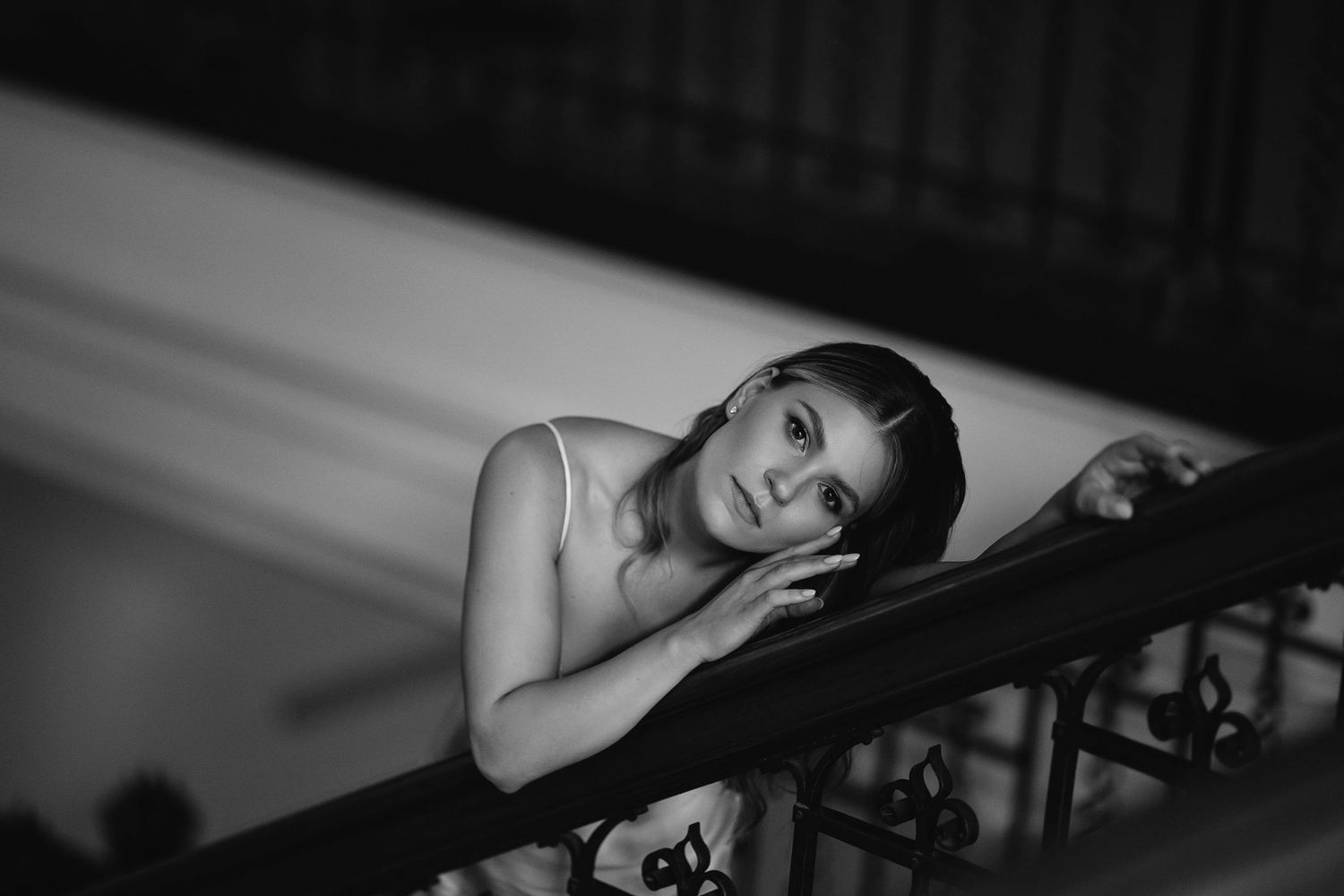 Black and white photo series of a person lying on a piano in different artistic poses and compositions.