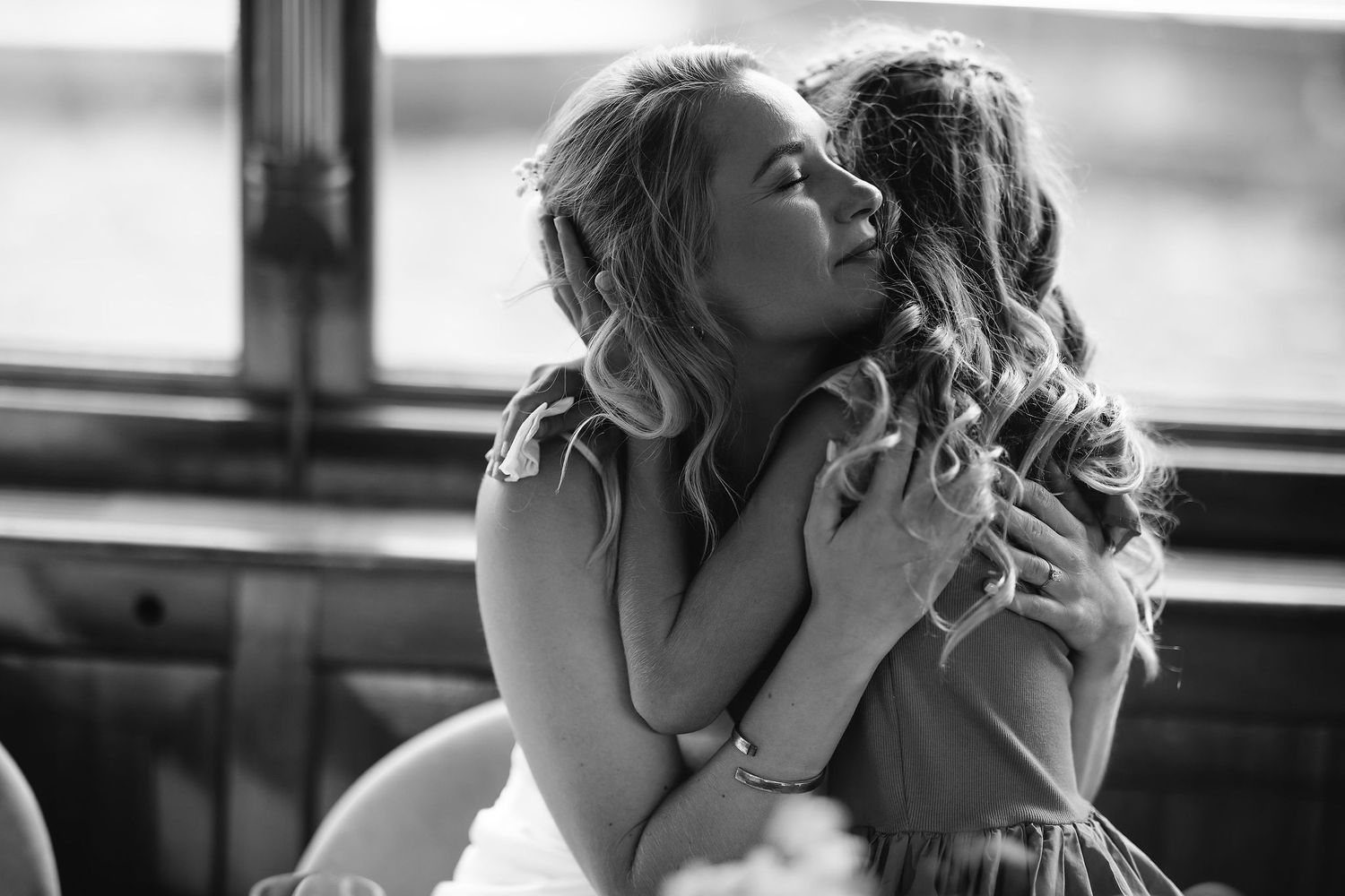 An intimate black and white emotional moment captured between two people at a wedding.