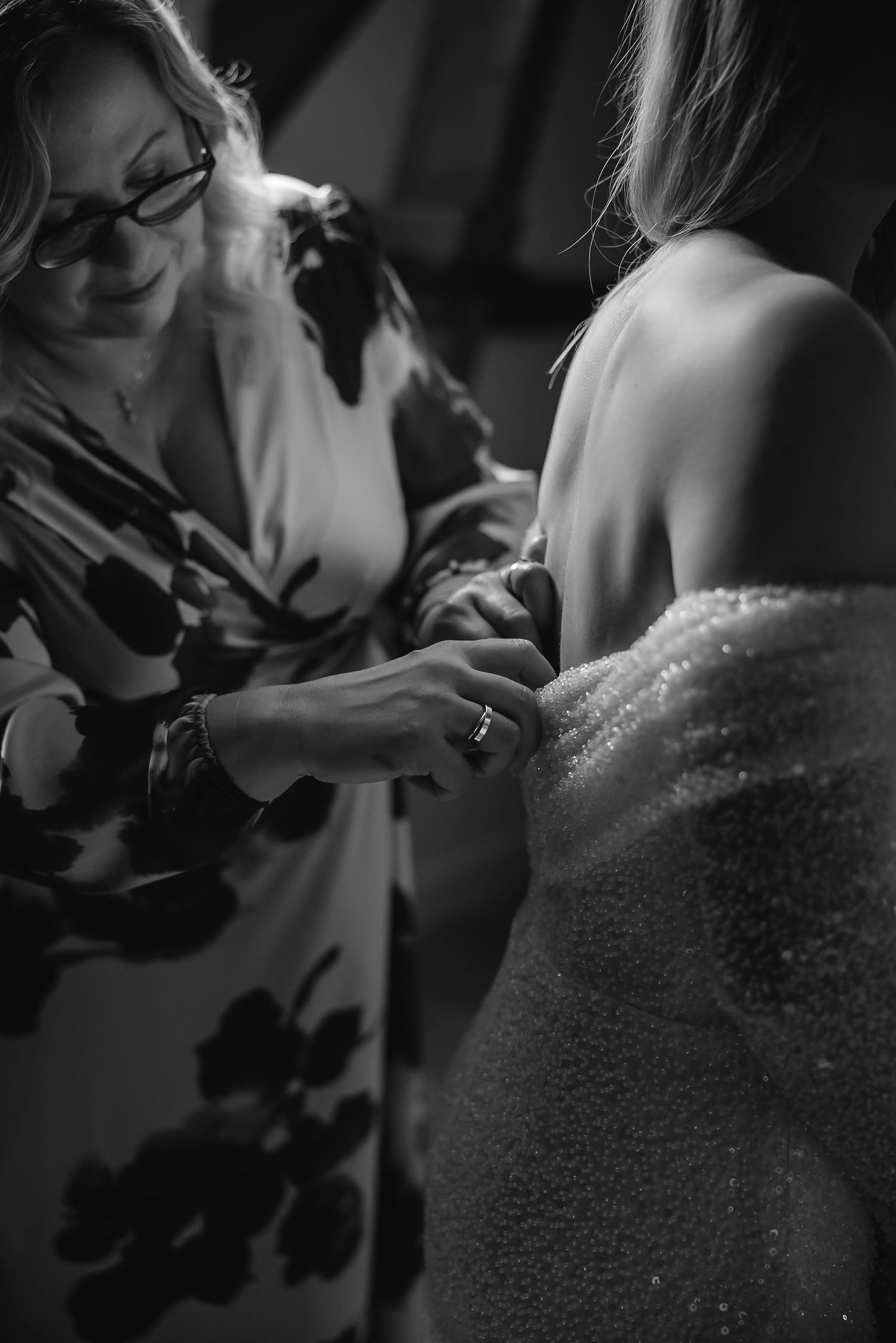 Close-up black and white shots showing details of dress beading and preparations.