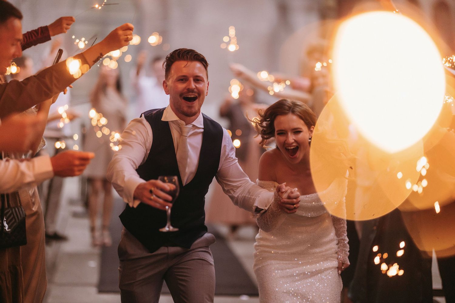 Wedding celebration with sparklers creating magical light trails in the evening.