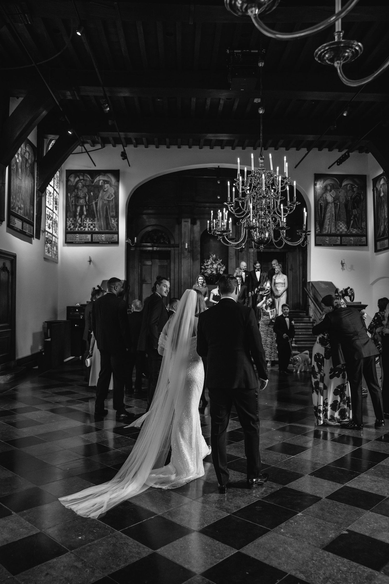 A series of black and white photos showing a couple dancing at their wedding reception in an elegant ballroom.