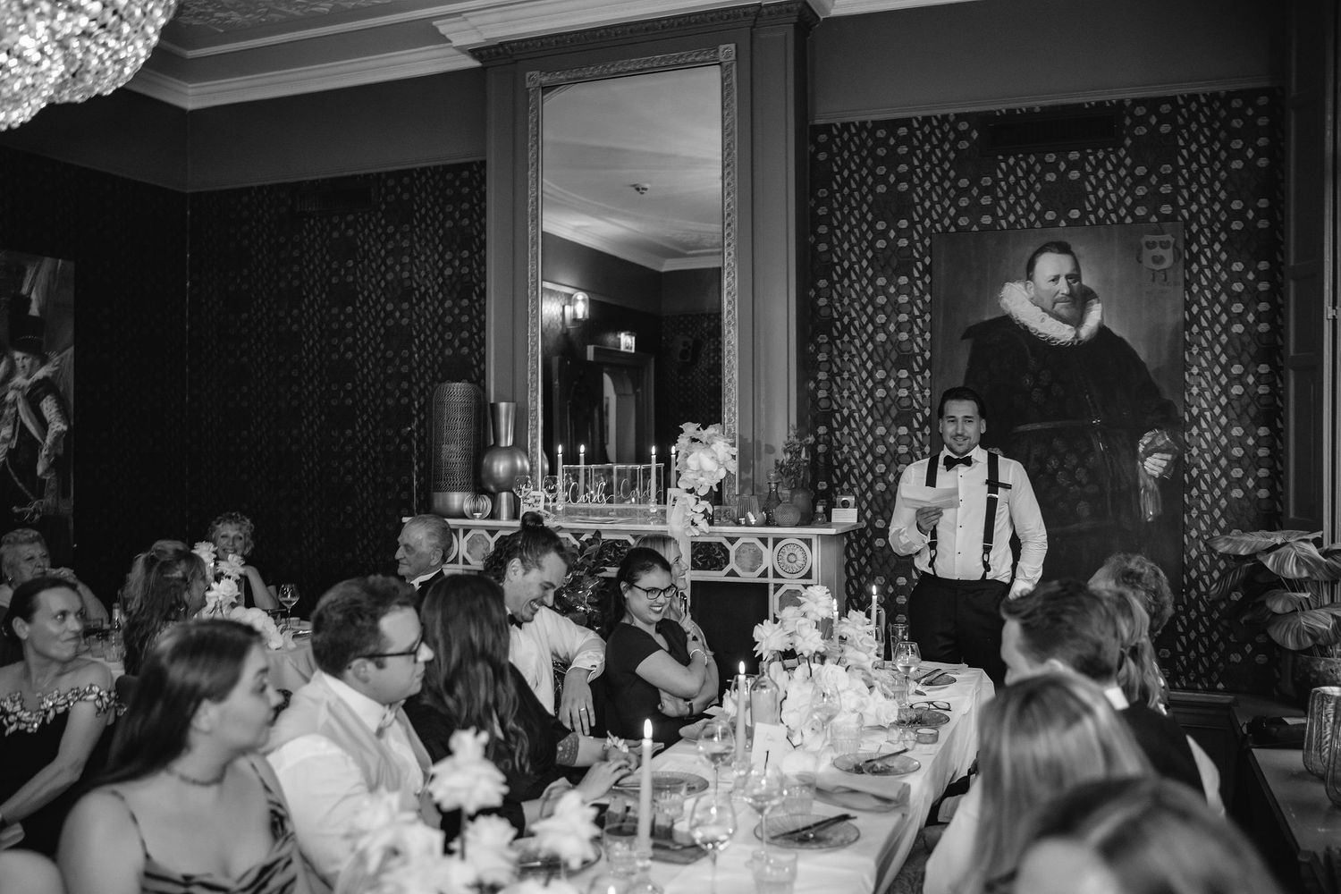 Wedding reception guests enjoying dinner and conversation at elegantly set tables.