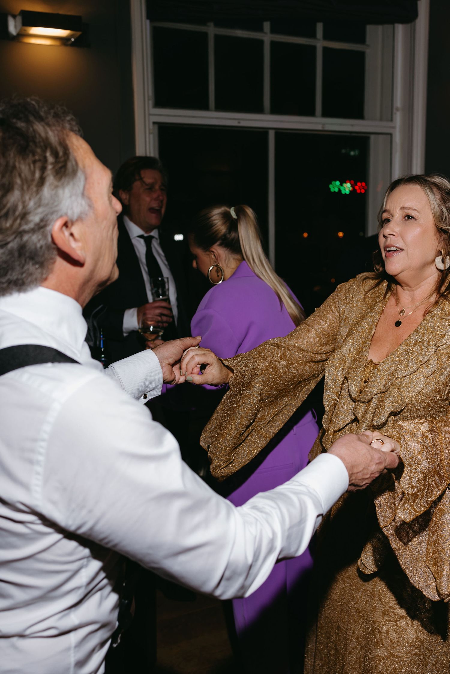 Lively dance floor scene with guests enjoying wedding reception celebrations.