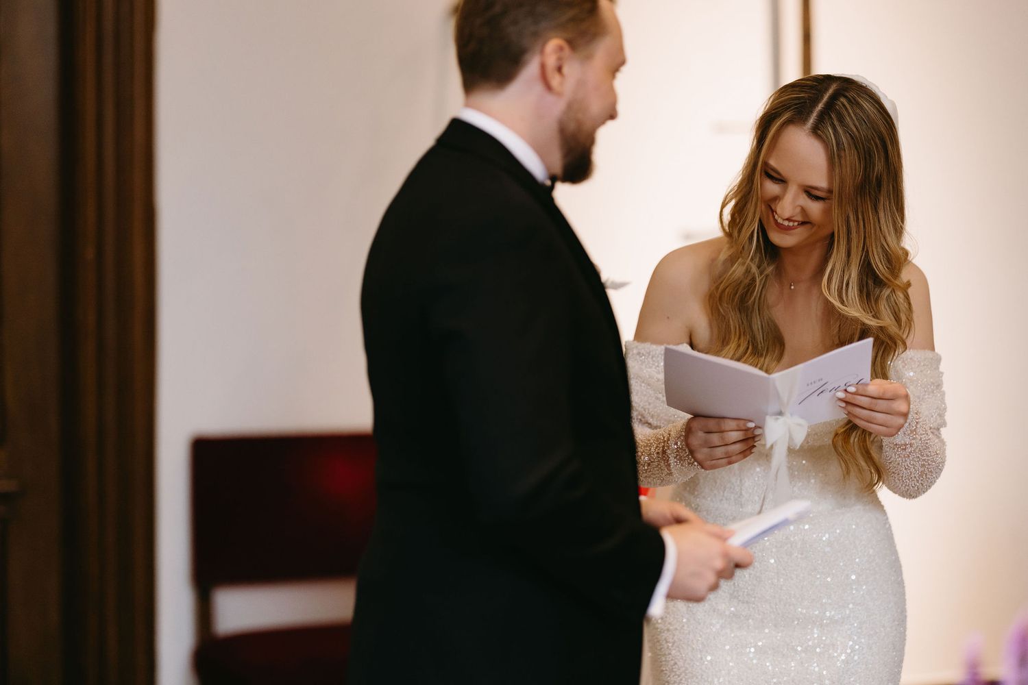 Couple sharing a heartfelt moment reading letters before their ceremony.