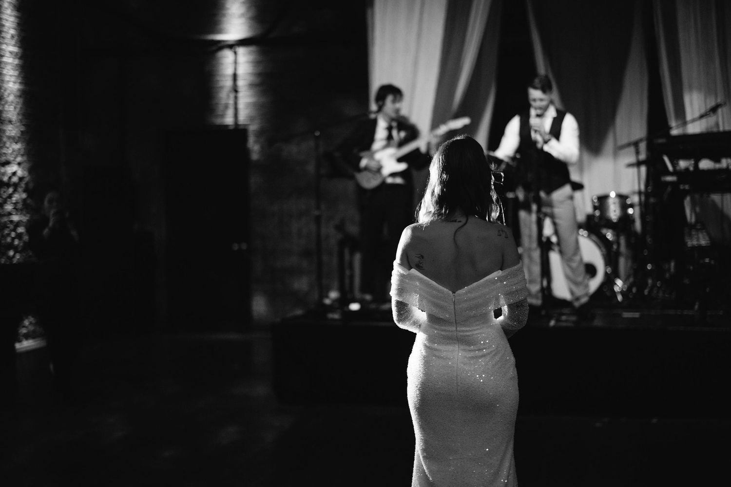 Dramatic black and white wedding moments captured in low light conditions.