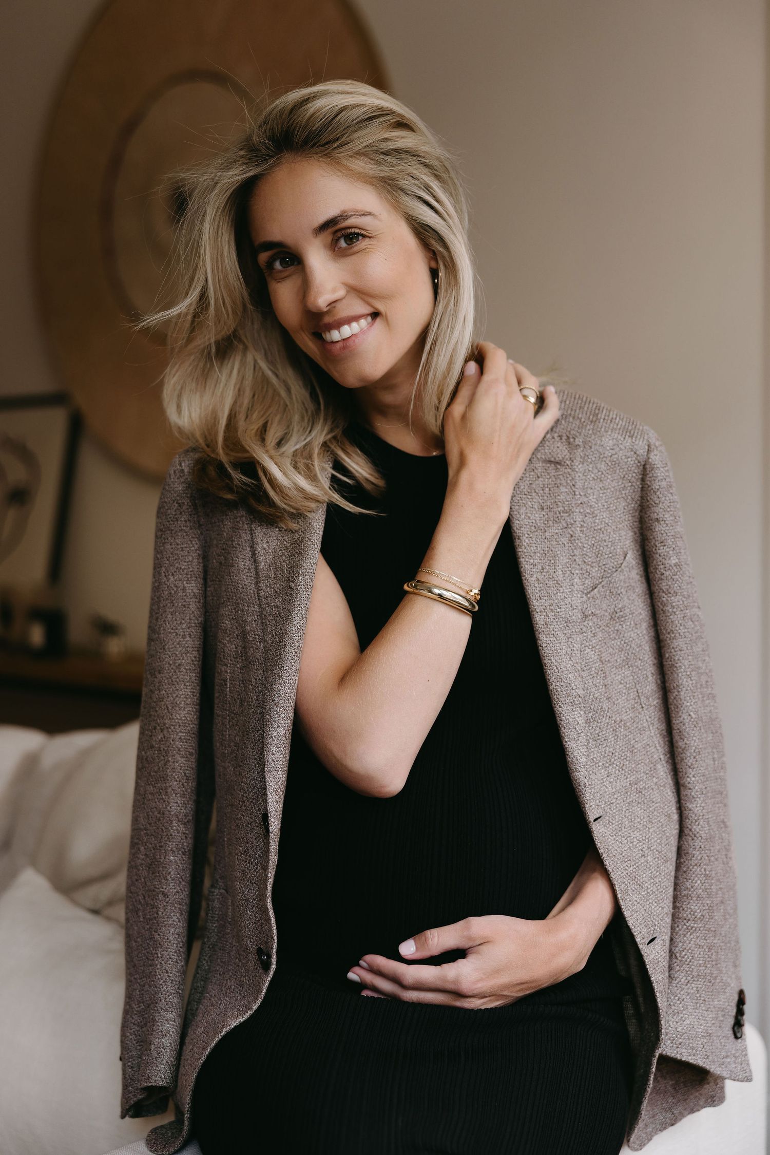 Fashion portraits featuring grey blazer and black outfit in natural indoor lighting.