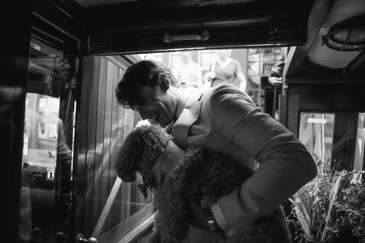 Black and white image showing preparation moments before a wedding ceremony.