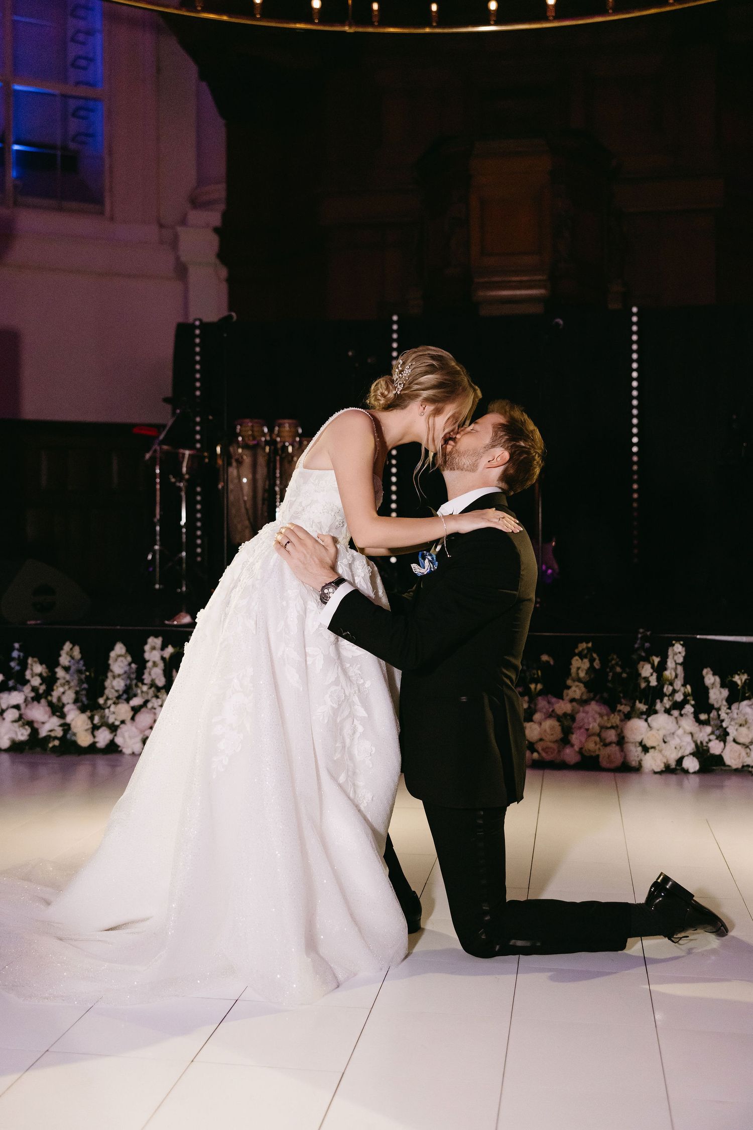 Intimate wedding dance captured in dramatic lighting with romantic ambiance.