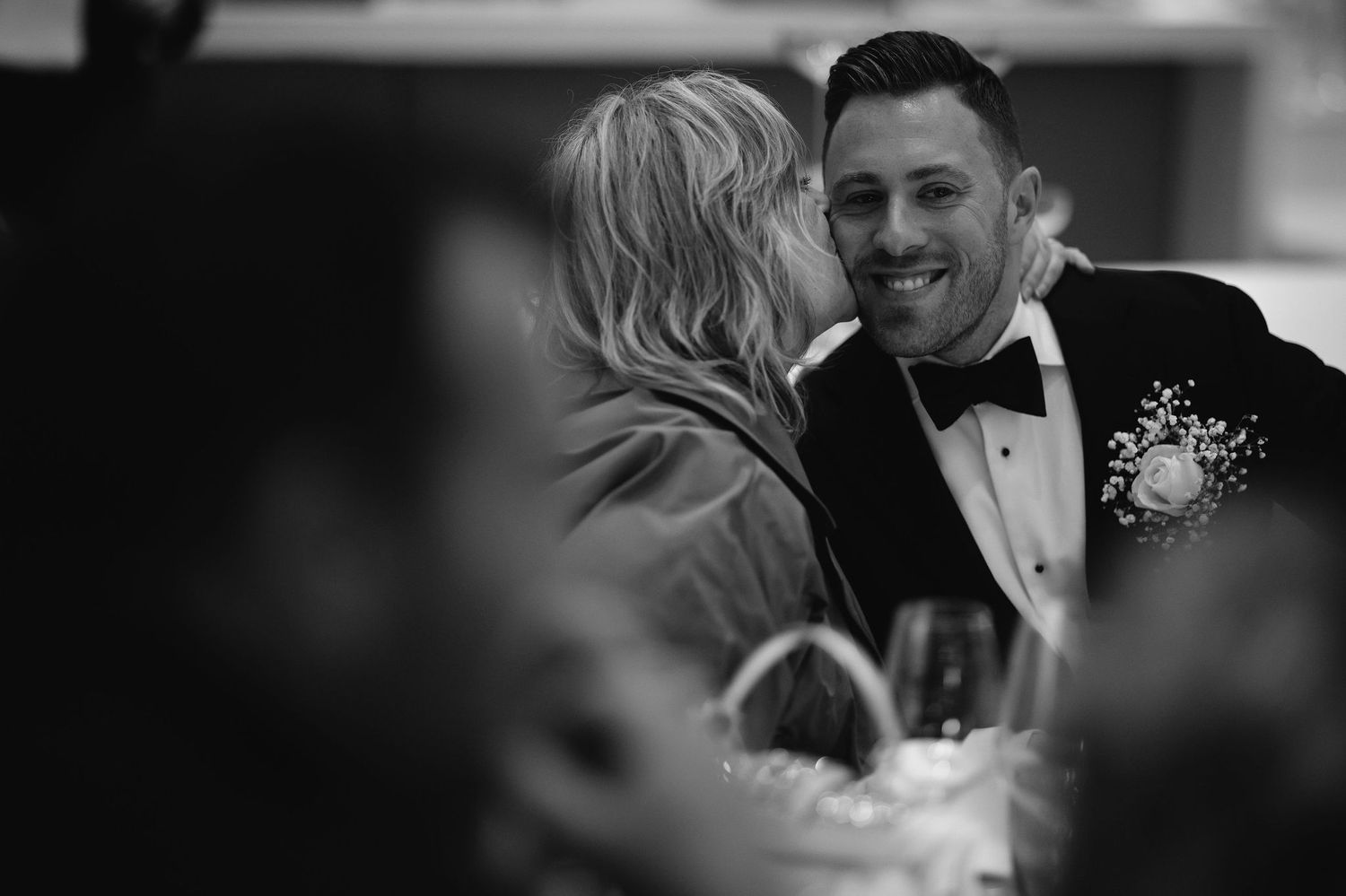 Black and white candid moments captured during an elegant wedding celebration.