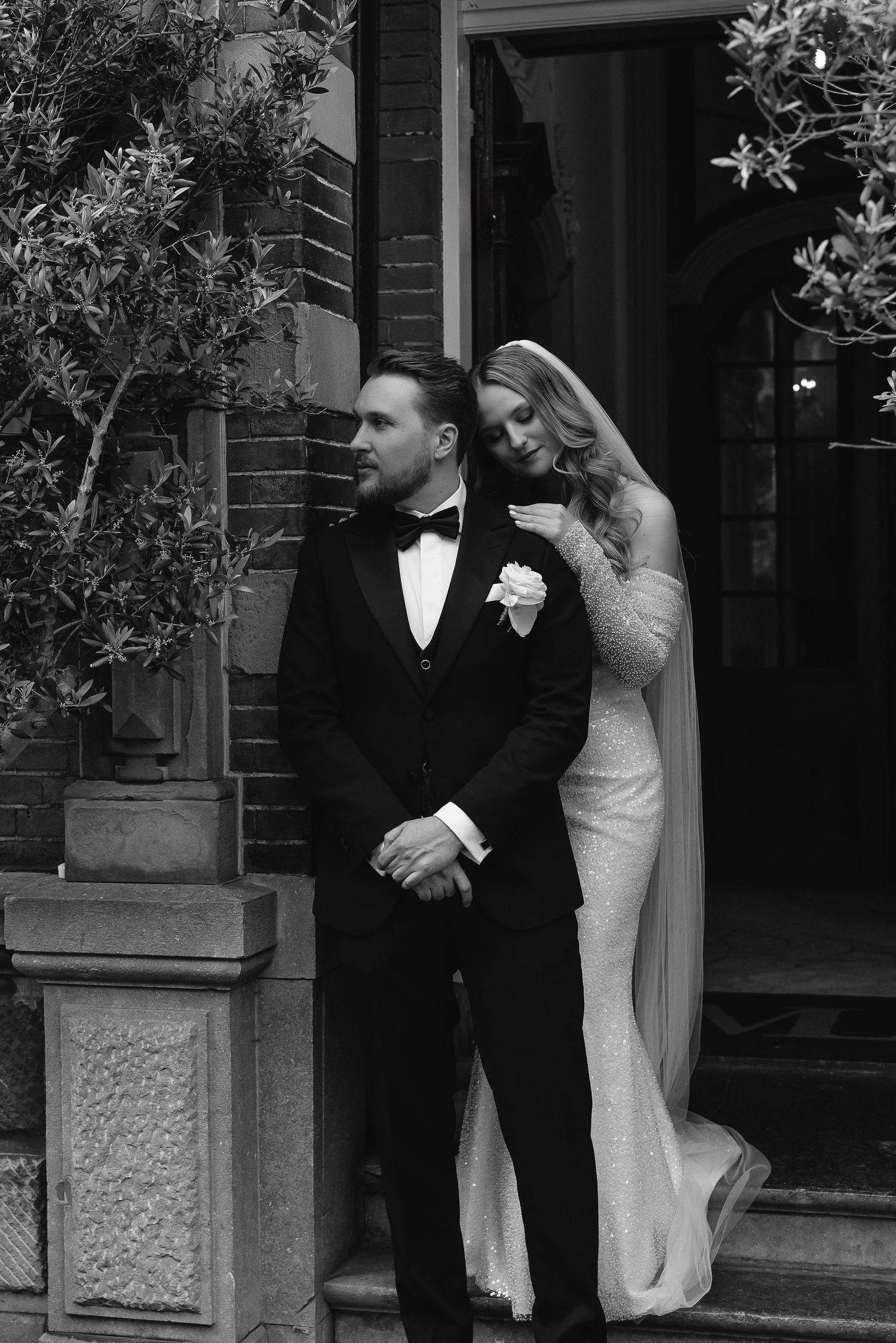 Classic black and white portrait on historic building steps.