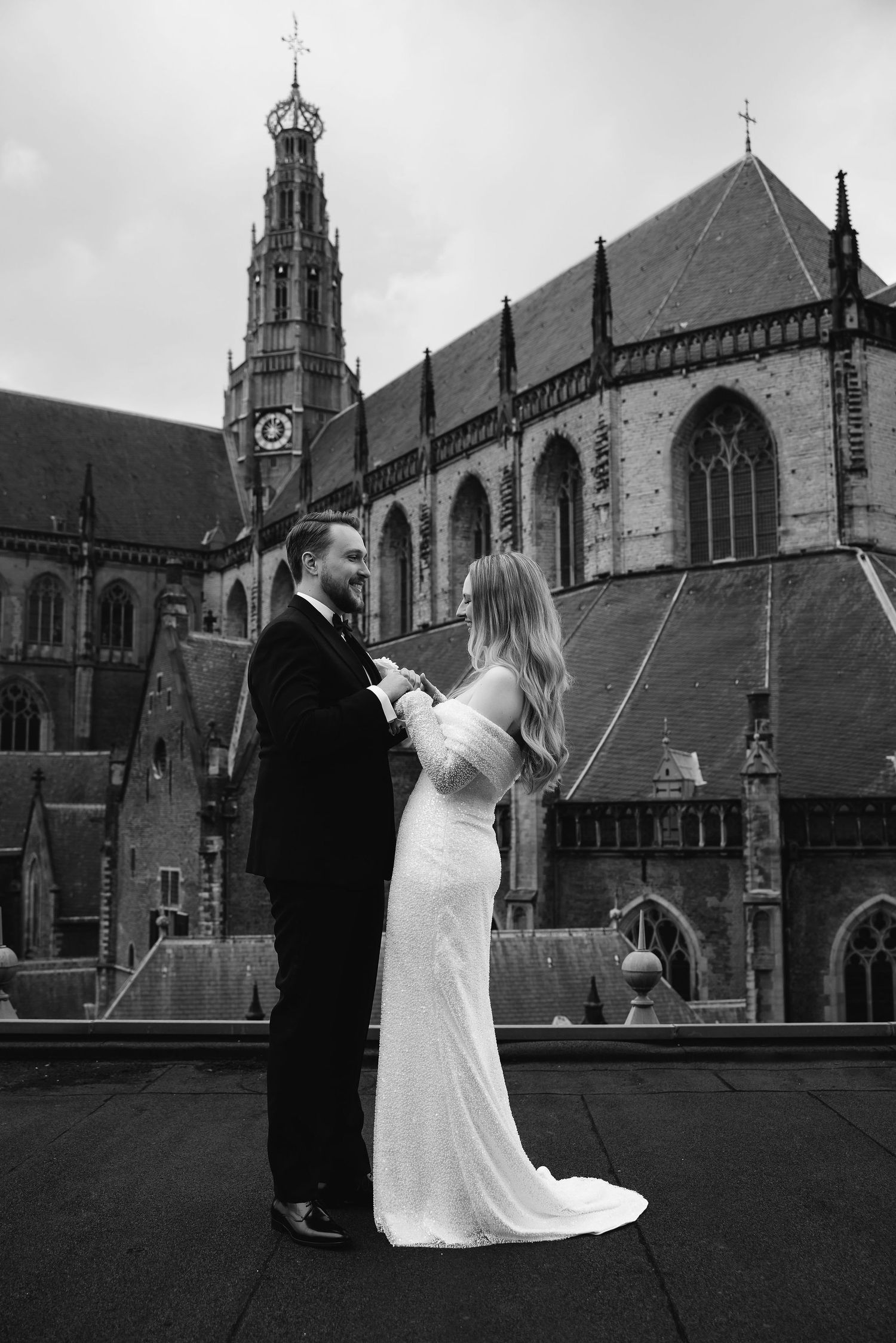 A romantic wedding photo session in front of a grand Gothic cathedral.