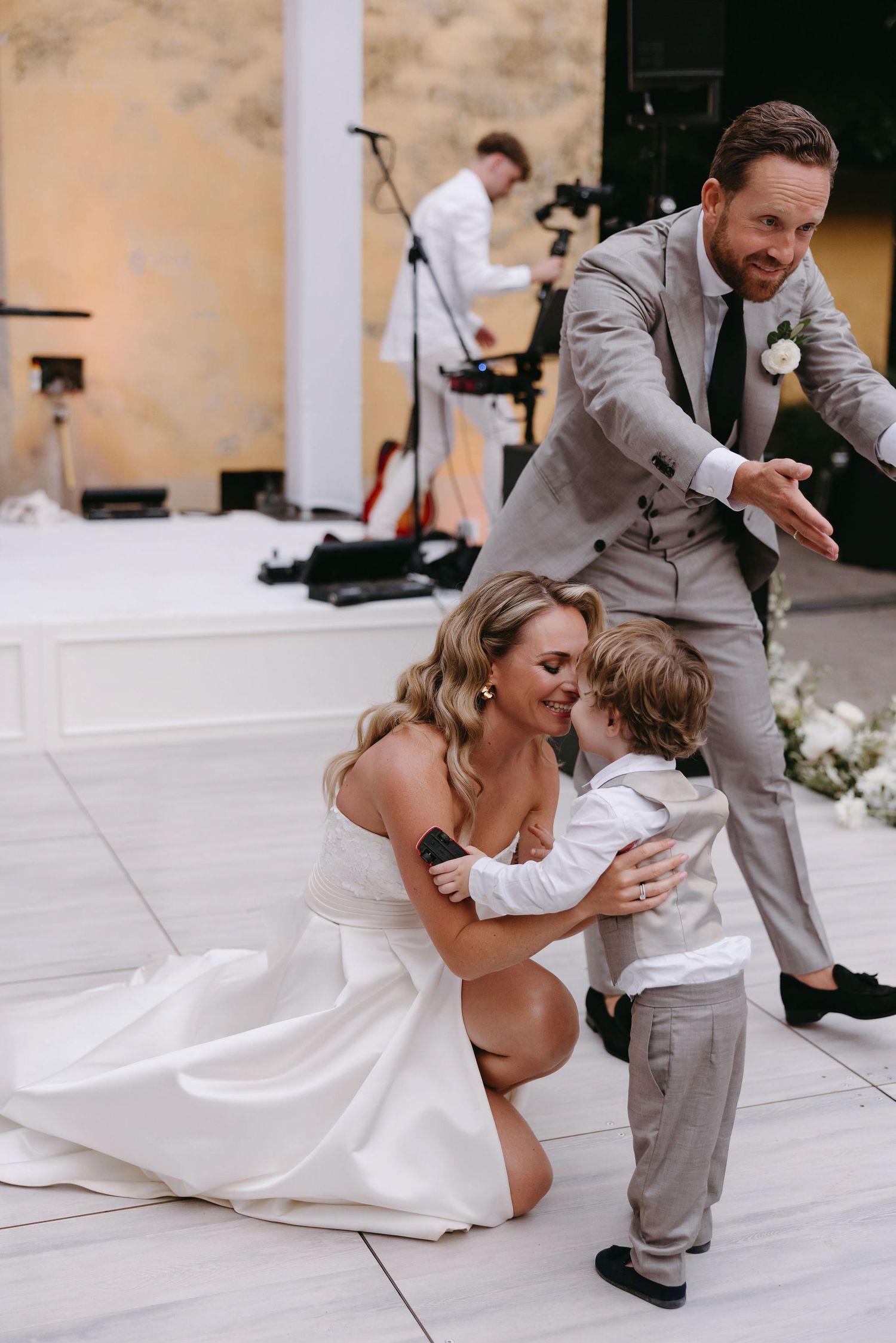 Joyful moment during a wedding celebration on an outdoor dance floor.