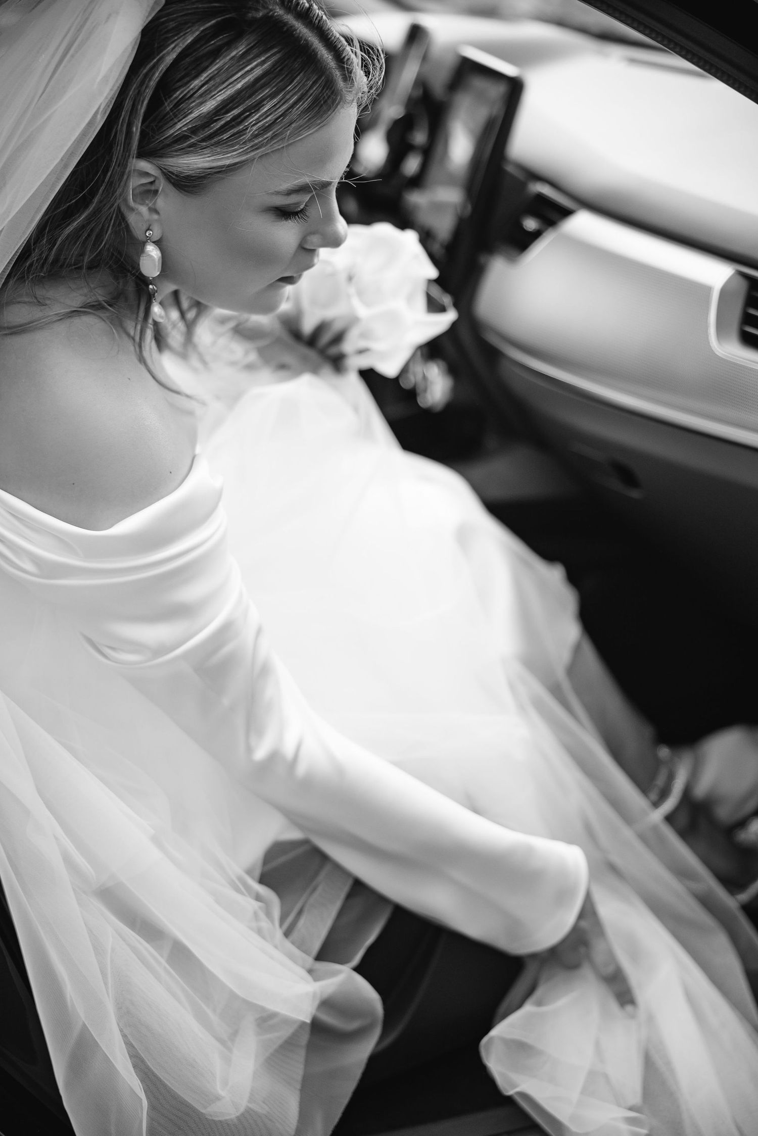 Black and white close-up shots showing details of a wedding dress and veil.