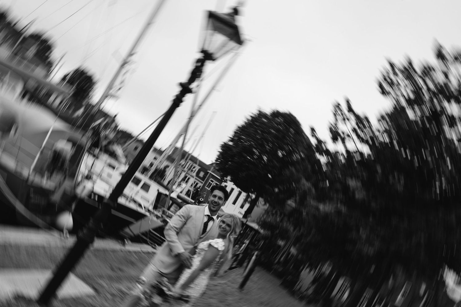 Artistic black and white motion blur photograph of a street scene with lamp post.