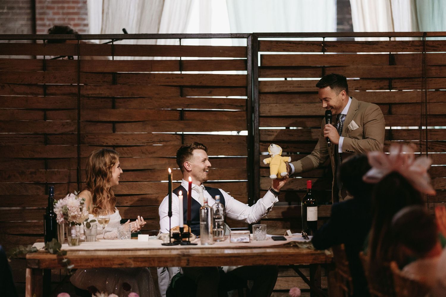 Intimate dinner gathering with guests seated at a table during an evening celebration.