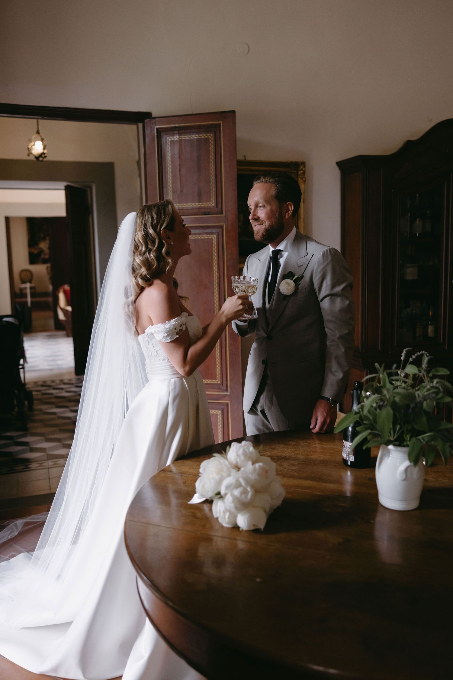 Wedding couple sharing a private moment in a rustic interior setting.