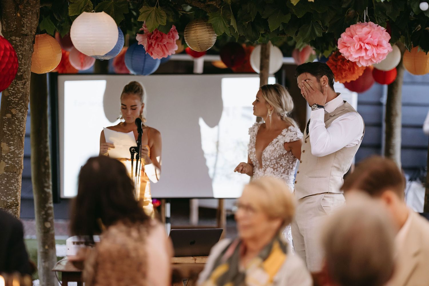 Wedding celebration with pink floral decorations and festive party atmosphere.