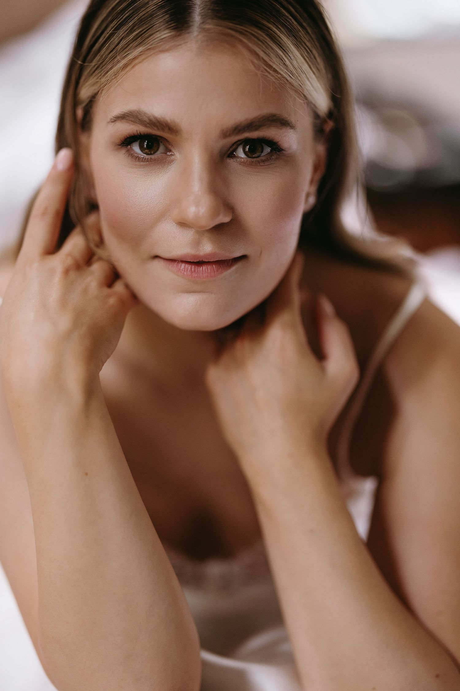 Close-up portrait with soft lighting and natural makeup.