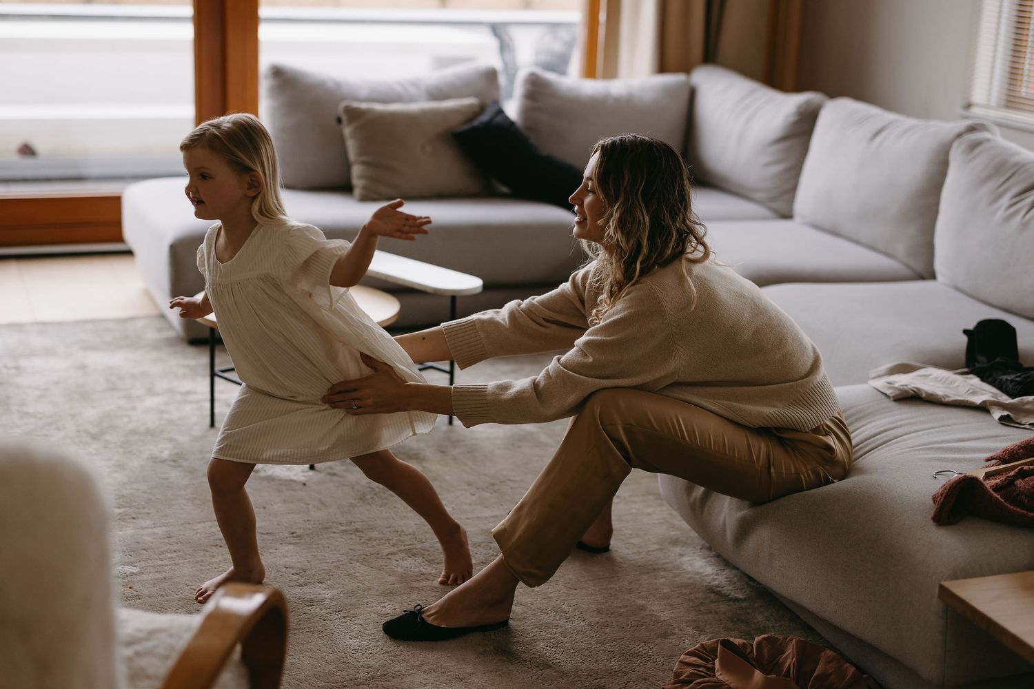 A candid moment of play and laughter in a cozy living room.
