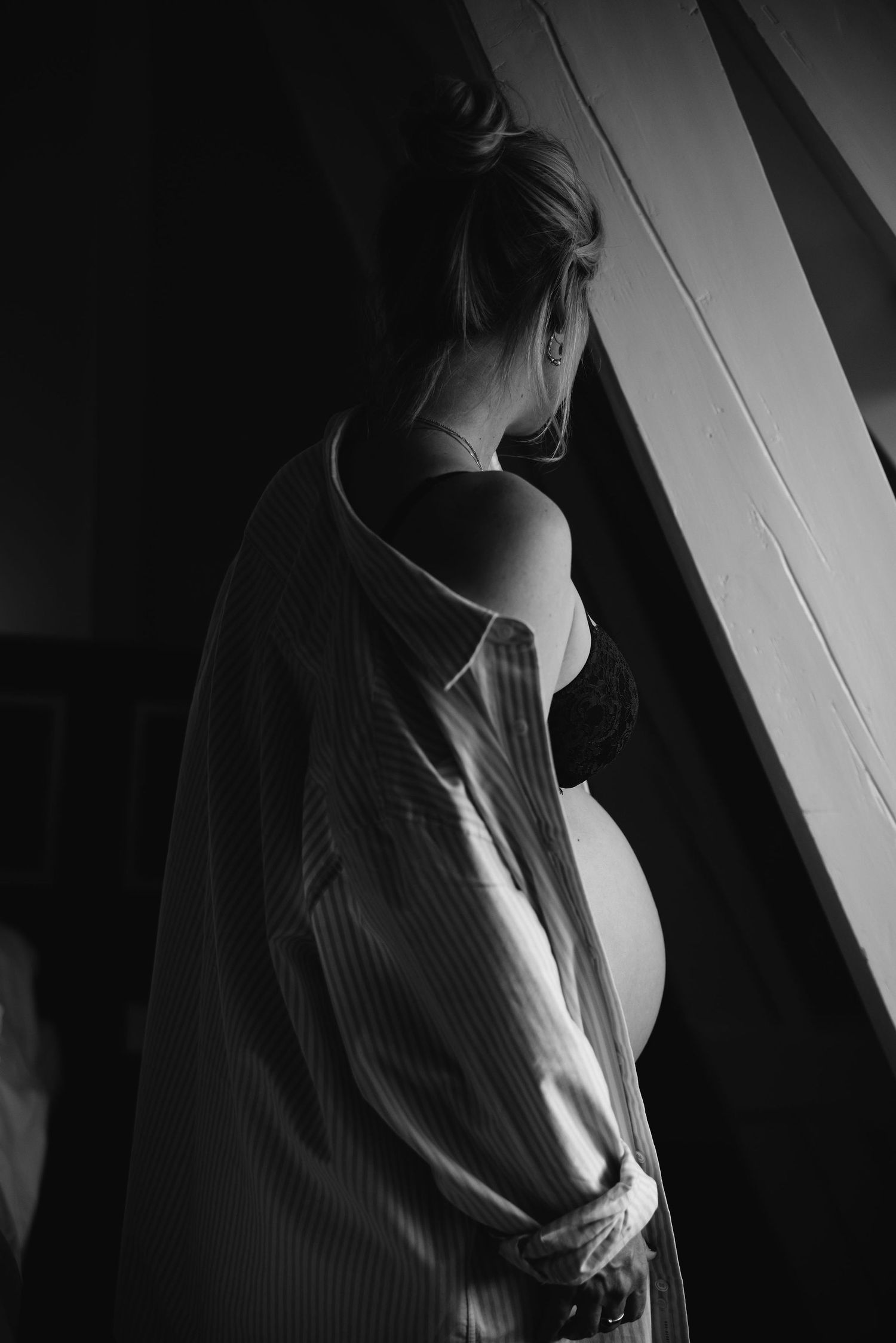 Dramatic black and white sequence showing a person's upper body and silhouette in shadow against a wall.