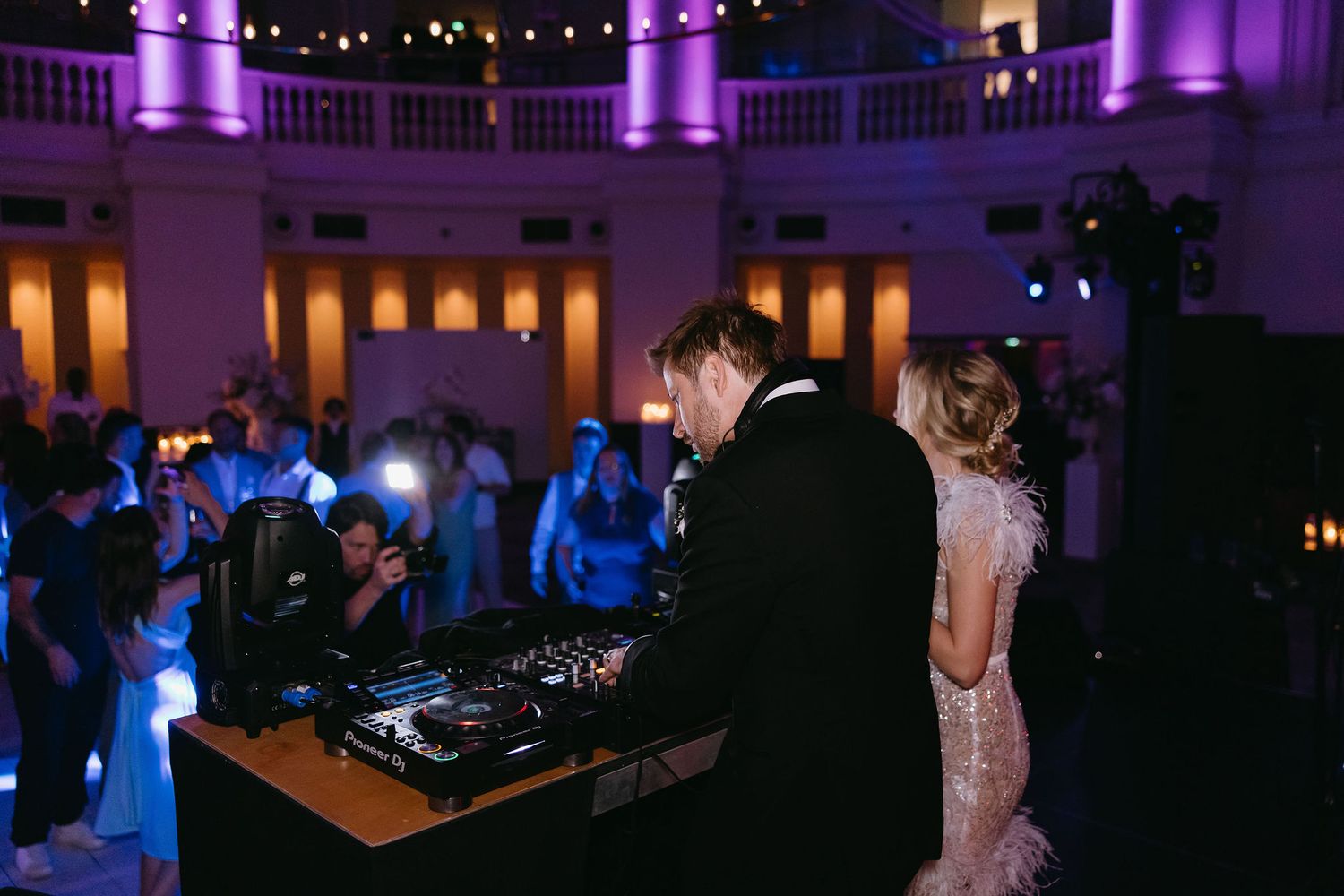 Reception venue with purple uplighting and romantic evening atmosphere.