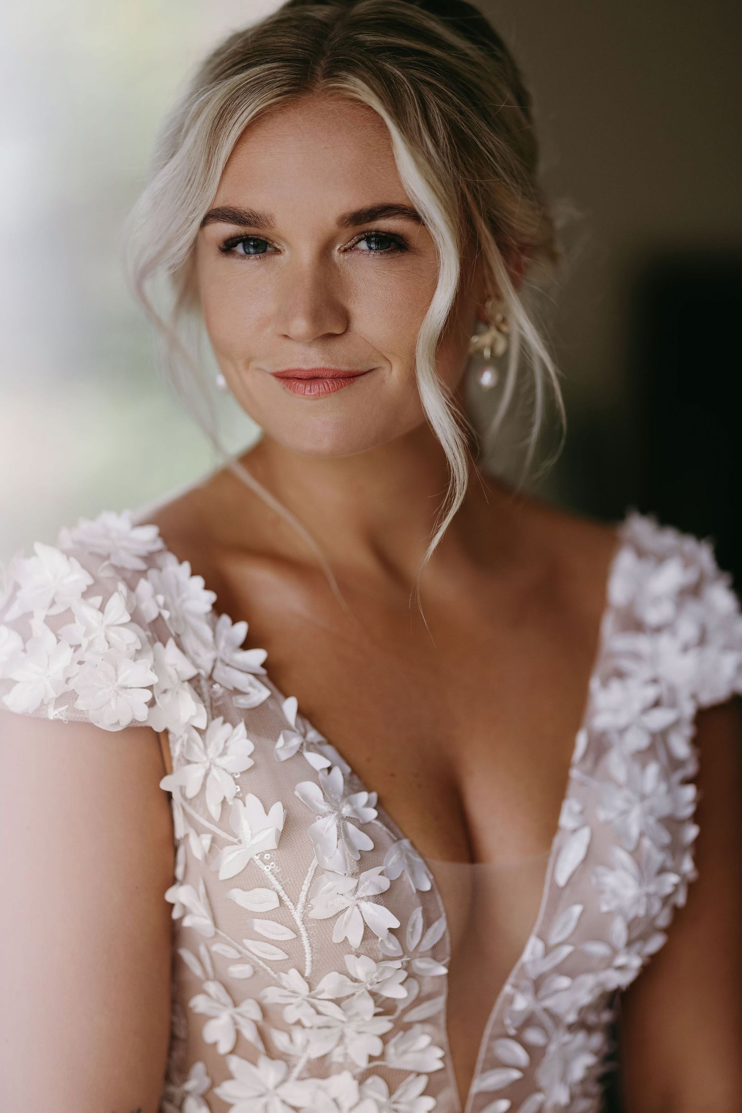 Delicate floral lace wedding dress with plunging neckline and cap sleeves.