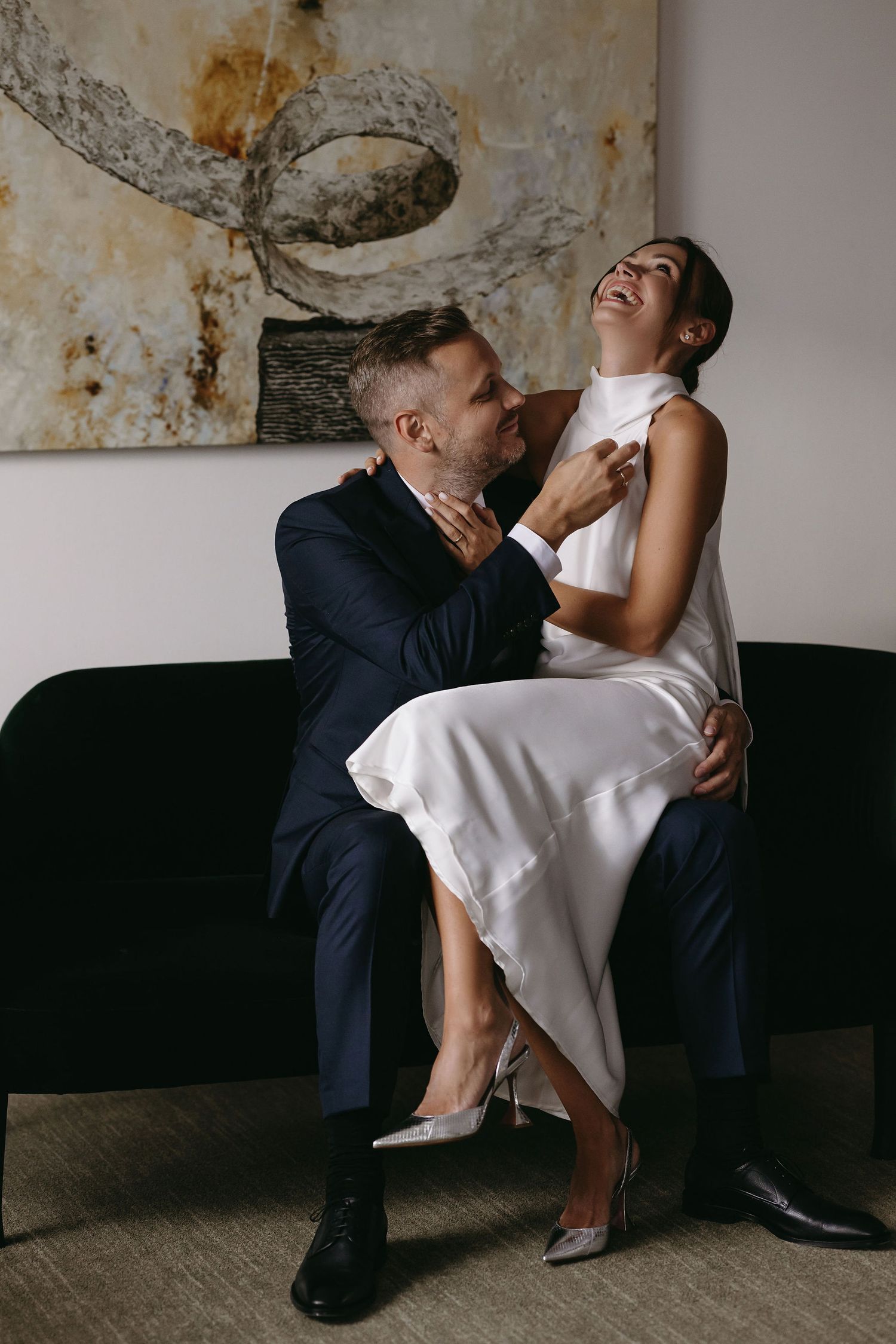 A romantic dance dip pose in a vintage indoor setting with contrasted light and shadows.