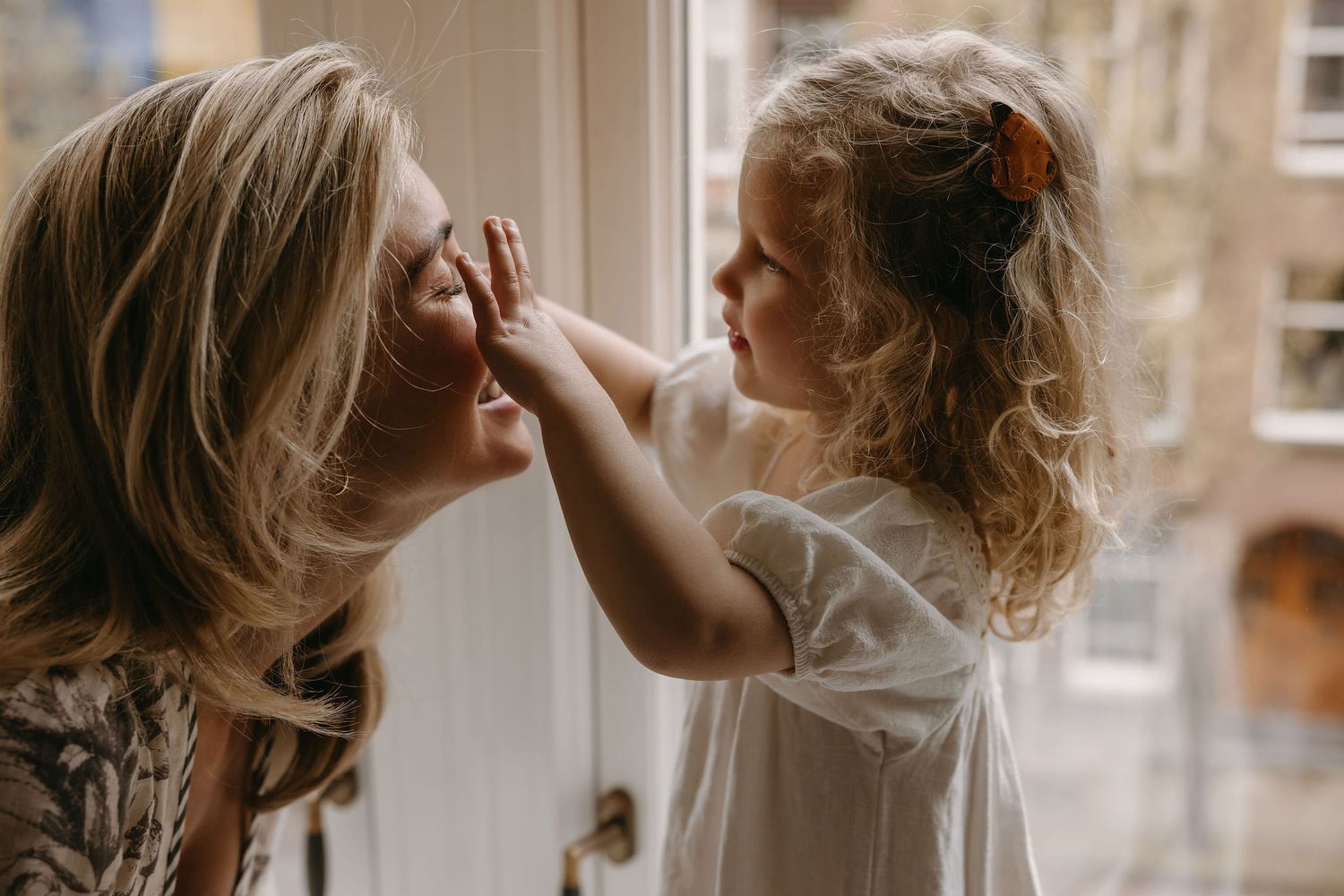 Intimate lifestyle photography series captured by a window in natural light.
