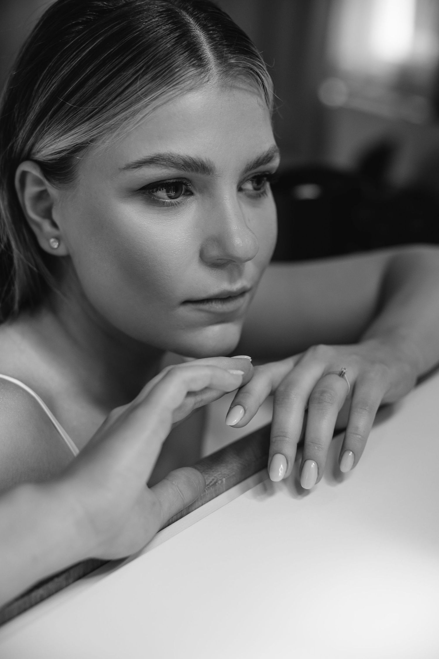 Intimate black and white portrait showcasing delicate features and natural beauty.