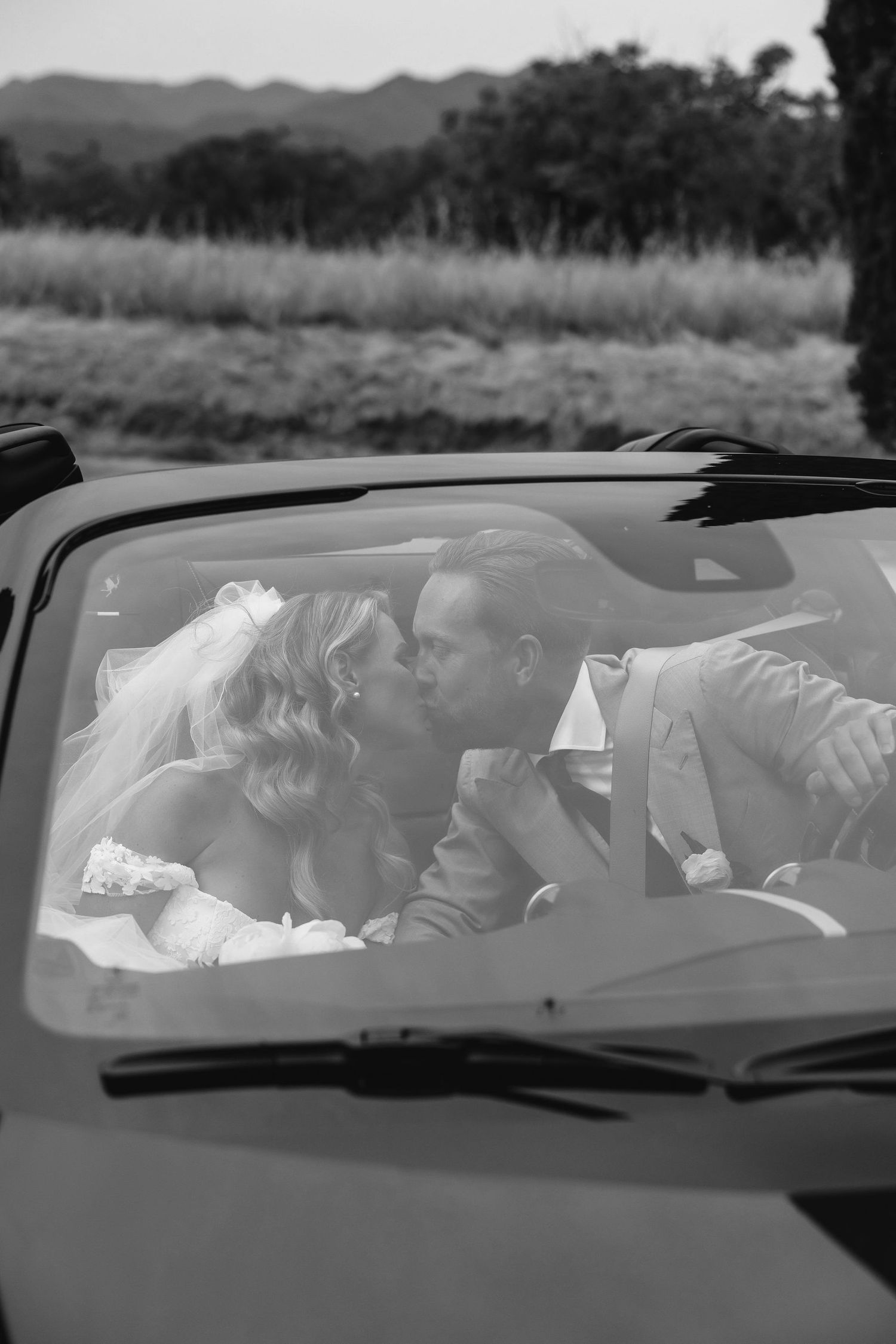 A sequence of black and white images showing a wedding couple seated in a car.