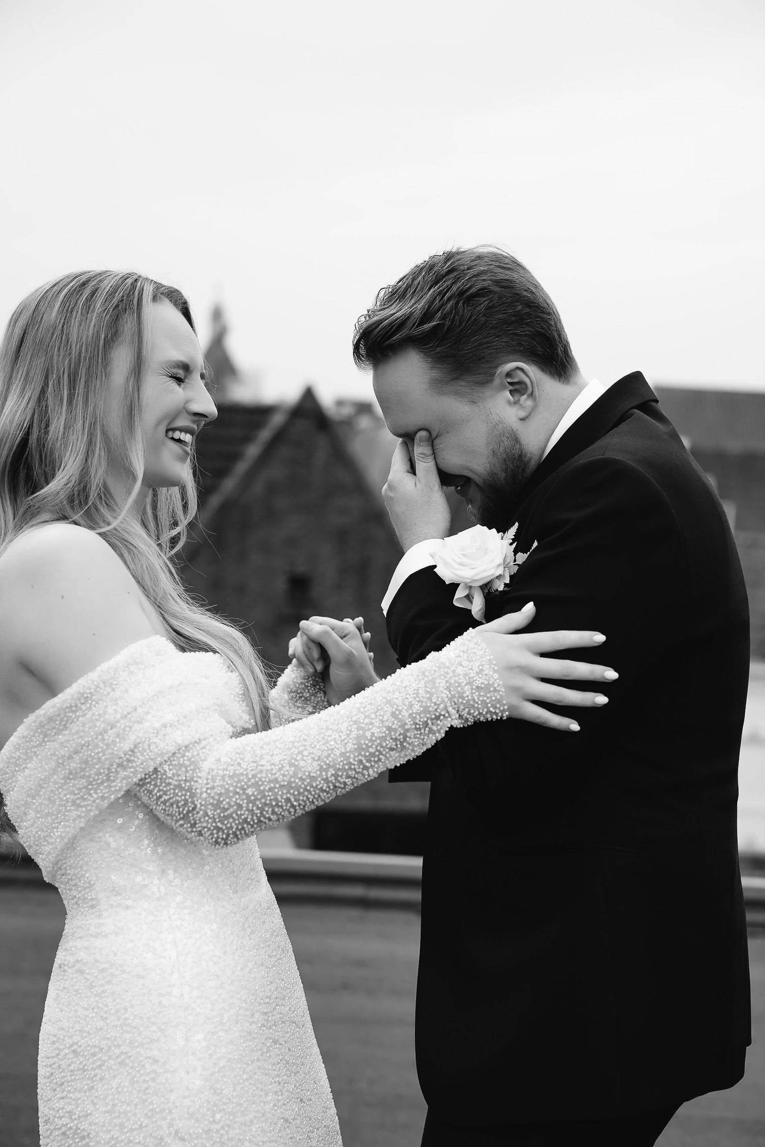 A candid emotional moment between a couple on their wedding day.