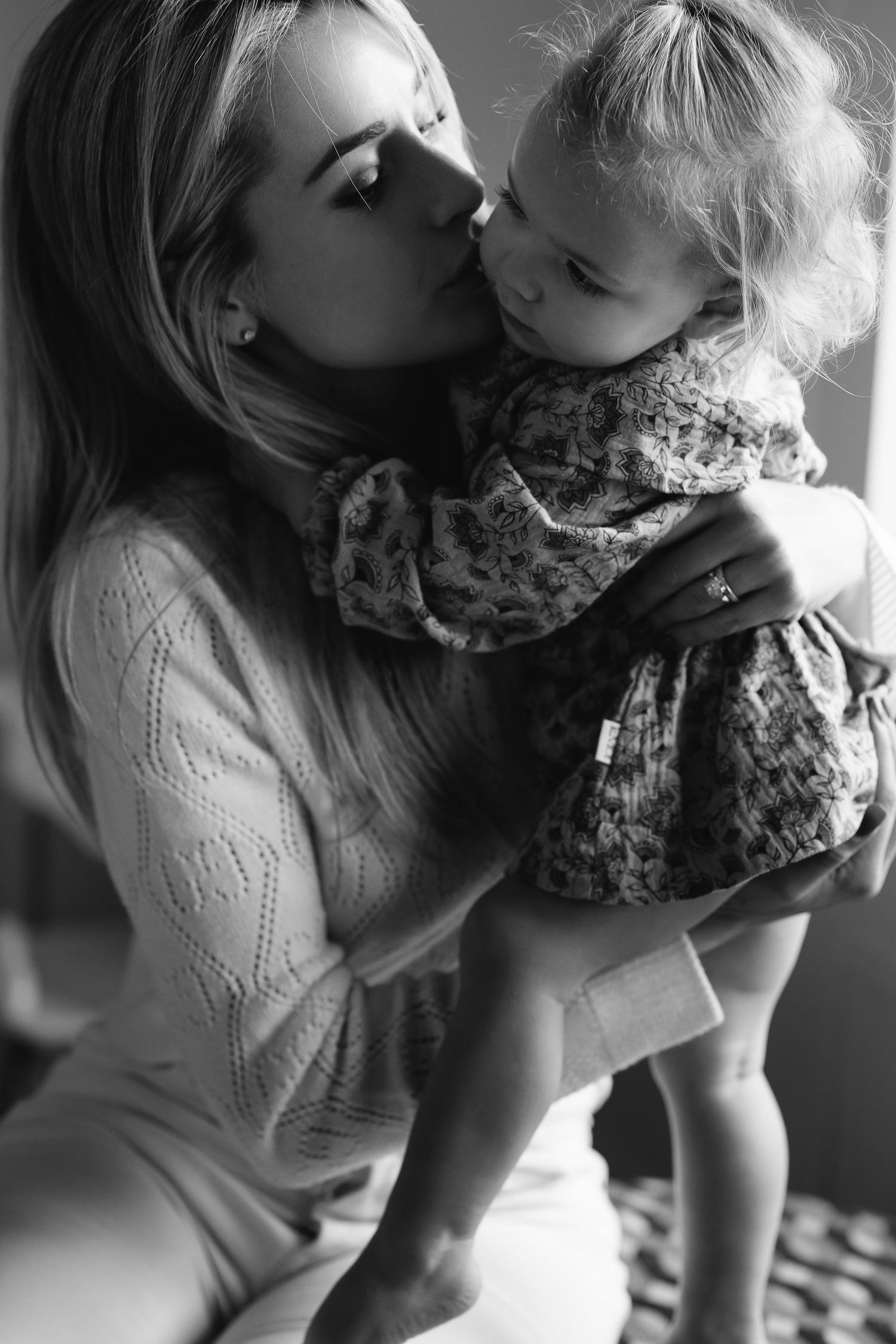 Black and white photo sequence showing tender moment between two people in casual attire.