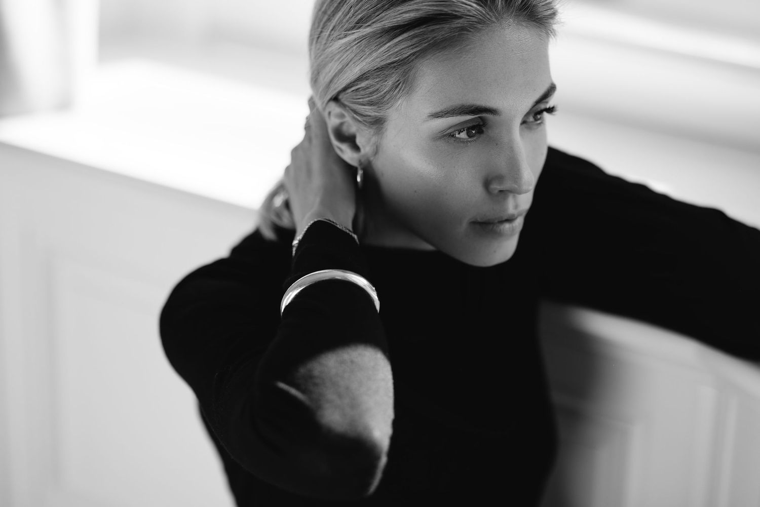Black and white portrait collage showing various moods and angles in elegant studio lighting.