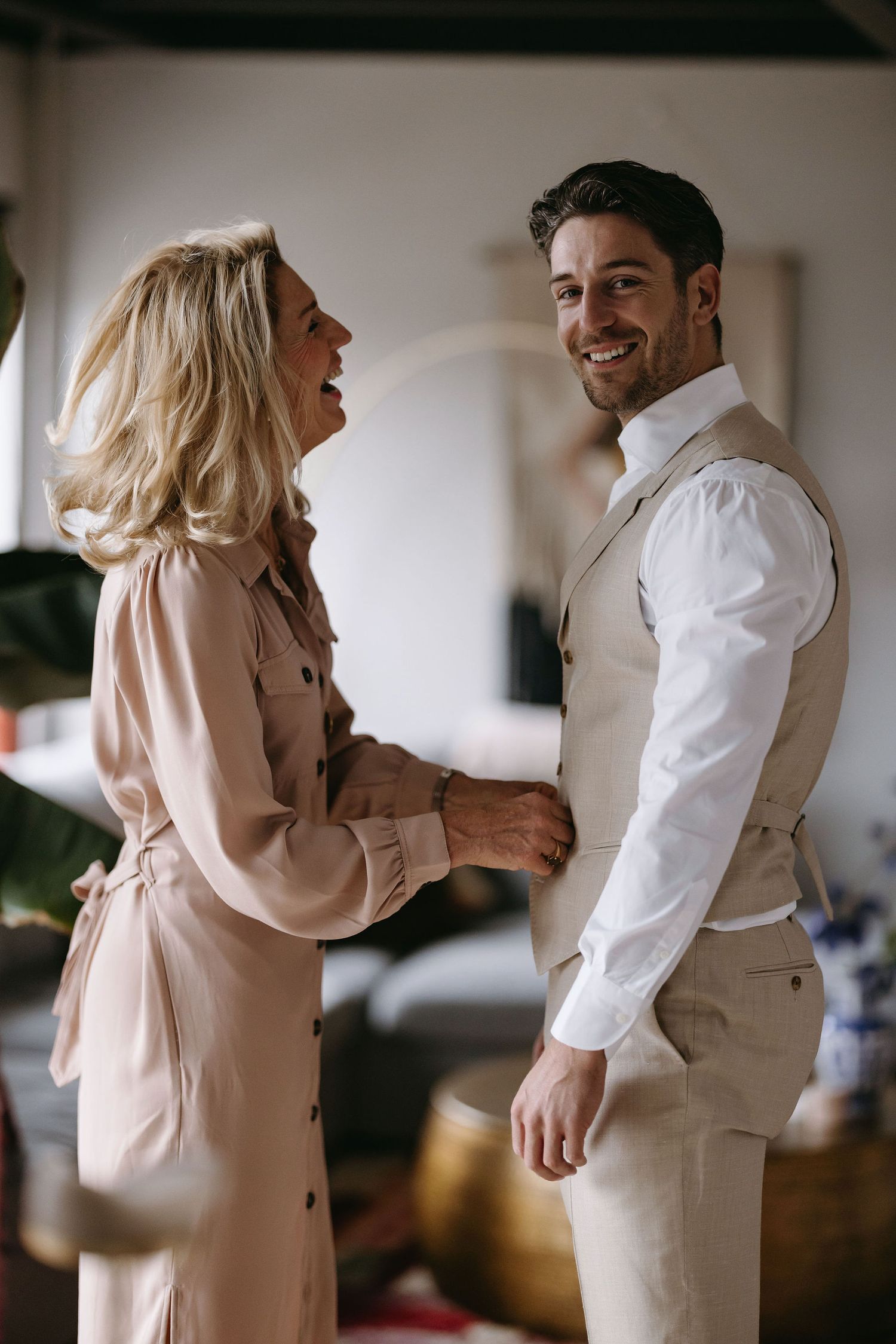 Wedding preparation moments in neutral tones with elegant formal attire.