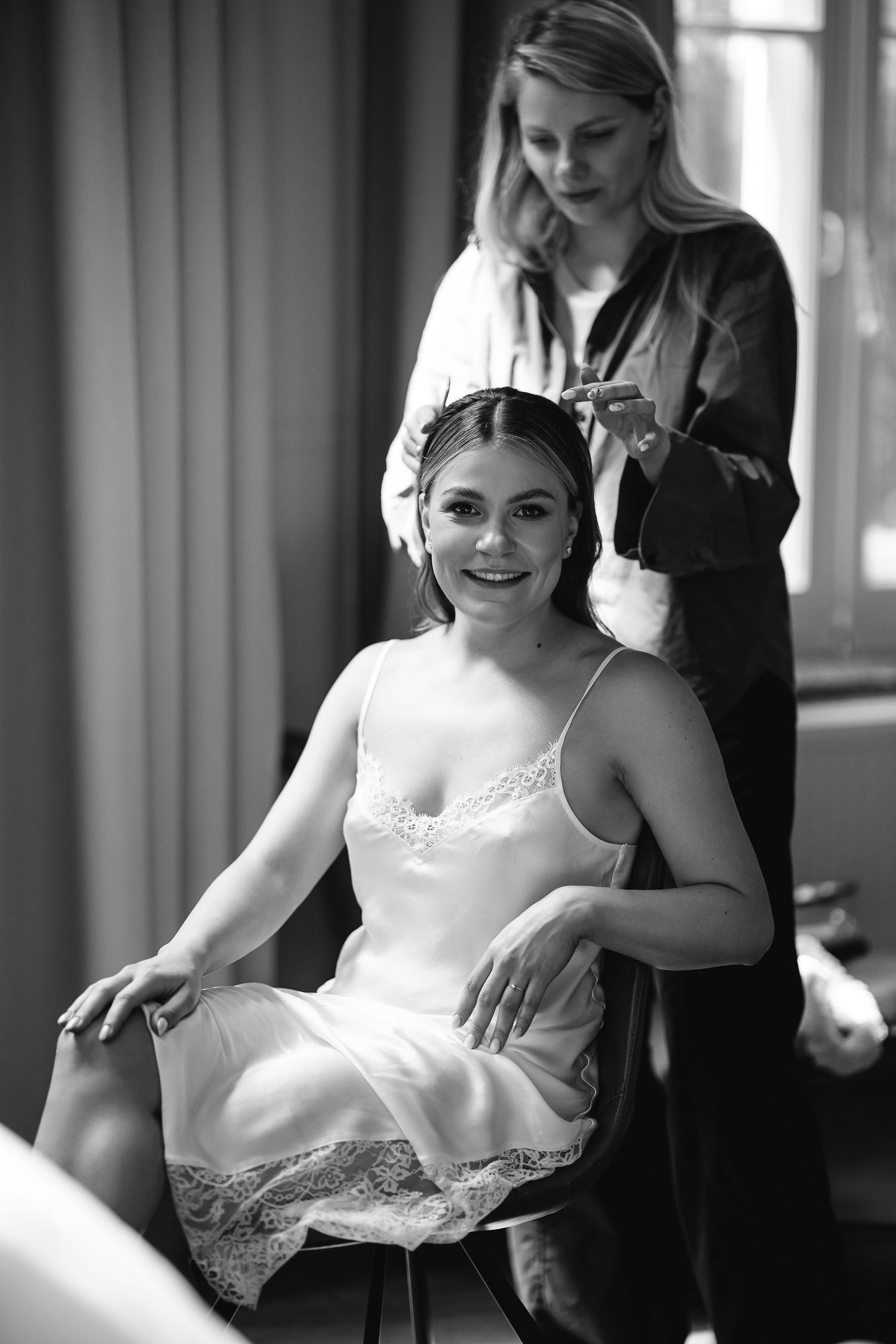 Black and white photo series of a bride getting ready in an elegant room.