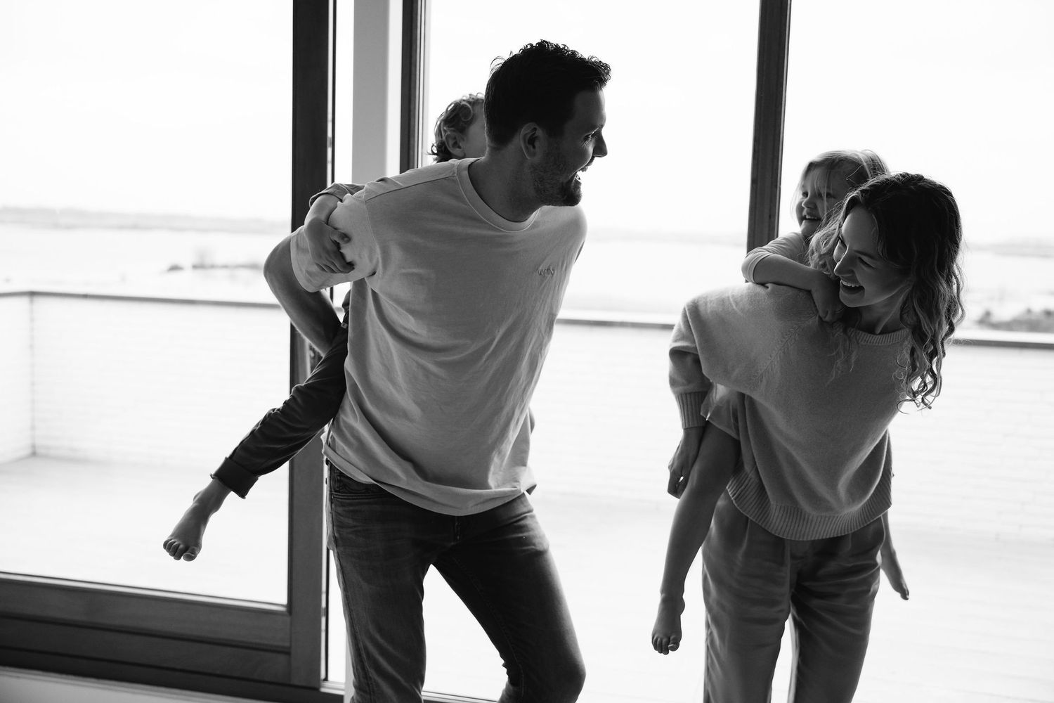 Black and white sequence of playful indoor moments between parent and child.
