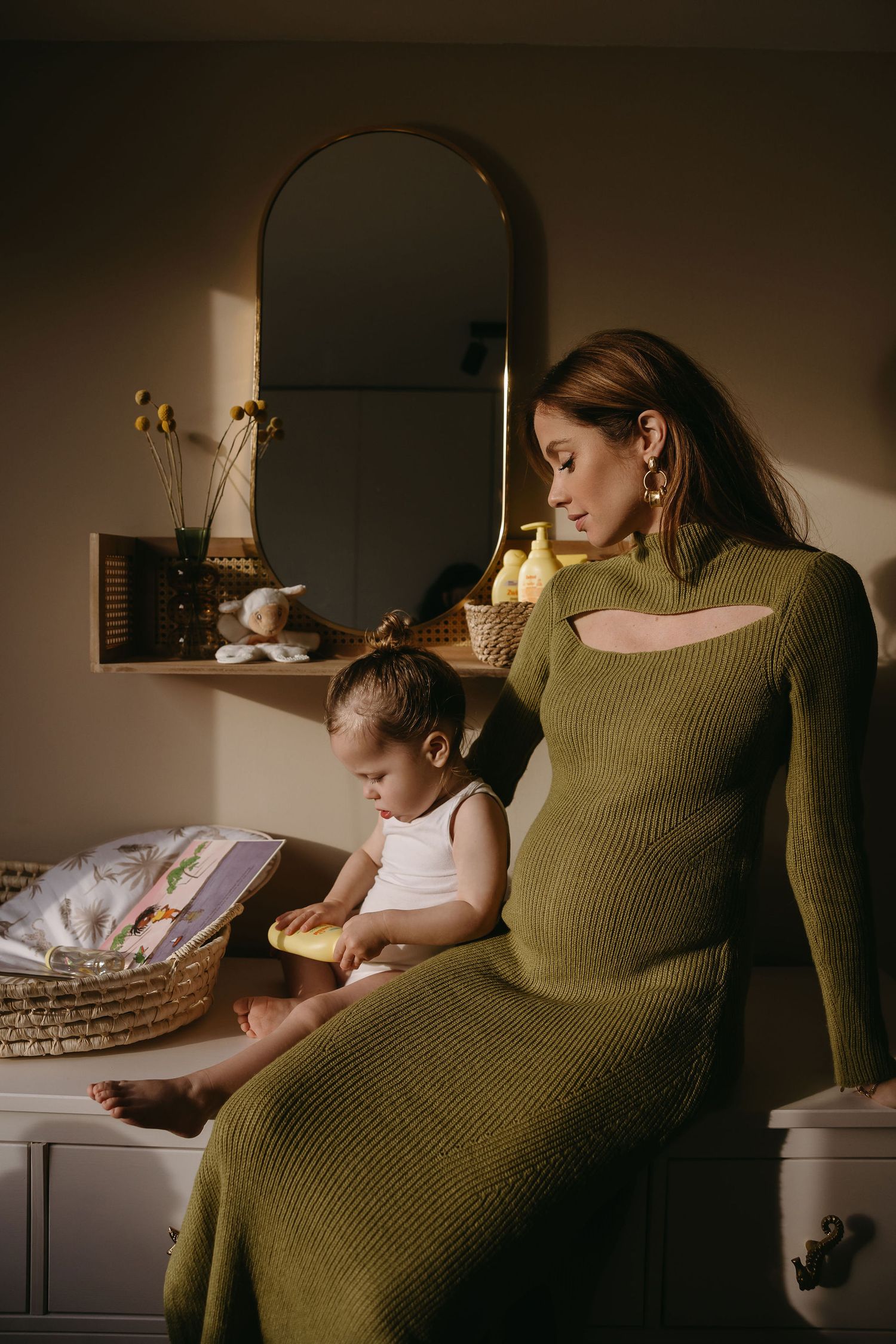 A quiet moment of bonding while reading together, captured in warm golden light.