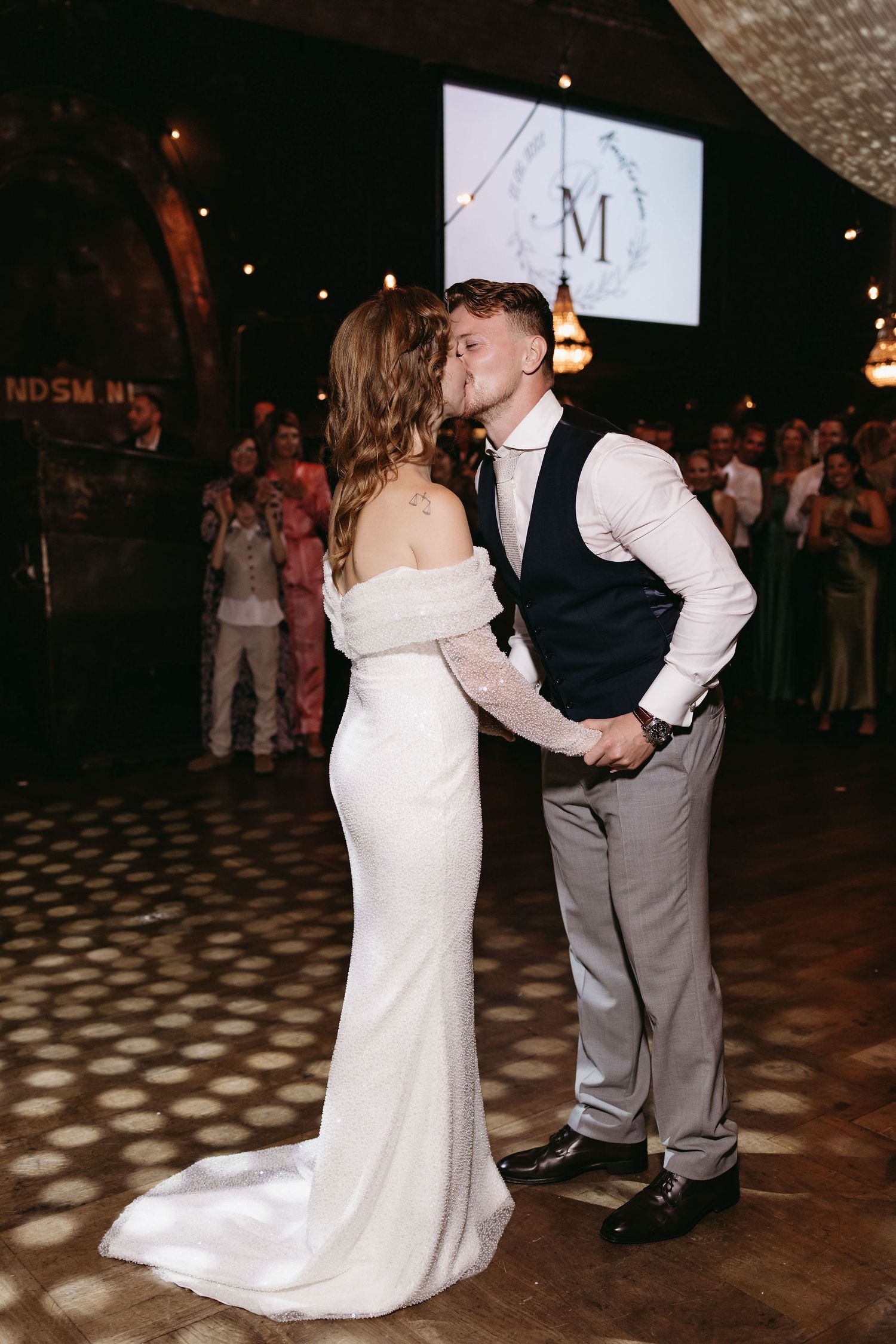 First dance sequence showing the couple twirling on a patterned dance floor.