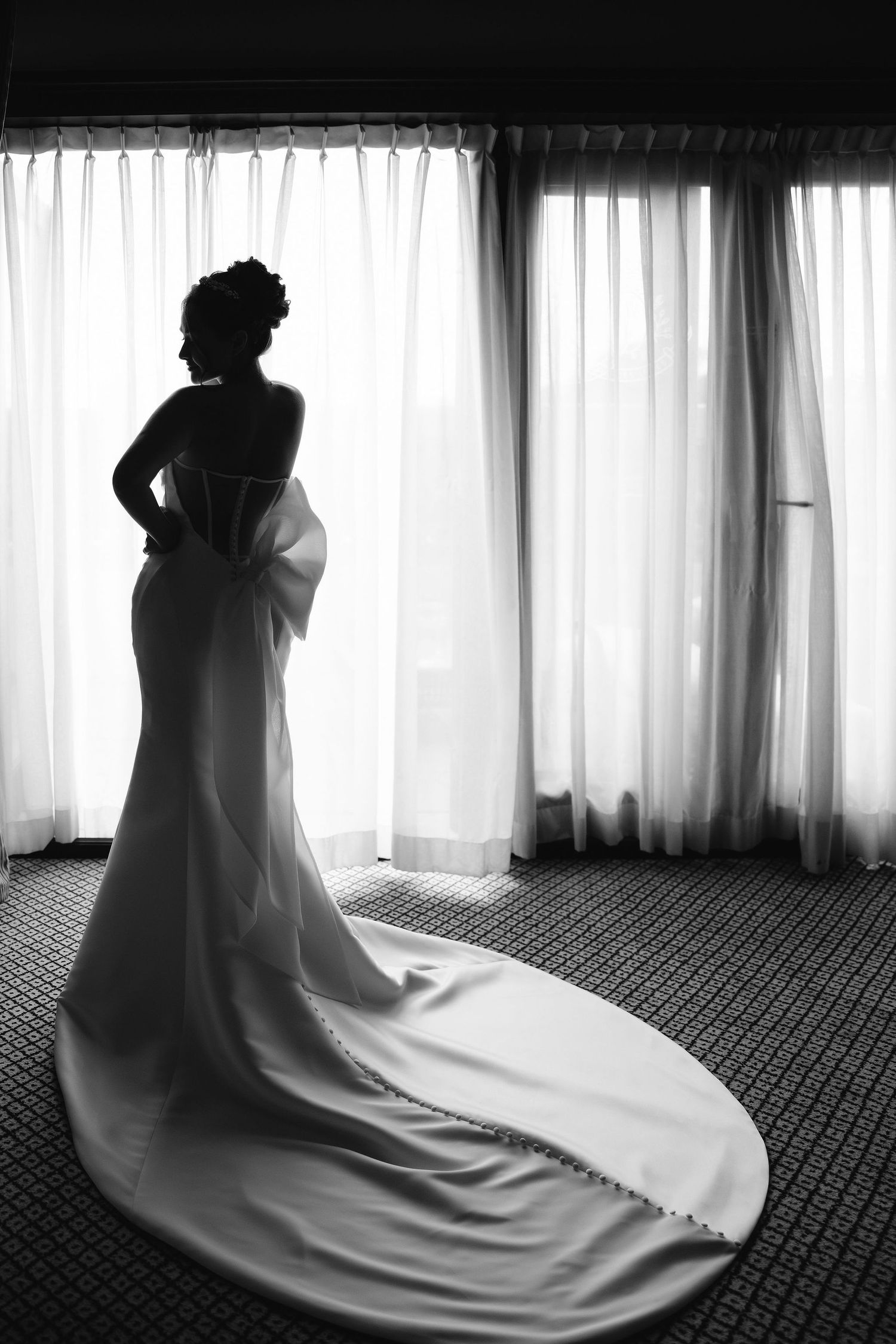 A silhouetted figure in a long flowing white dress poses by window light in a progressive sequence of four images.