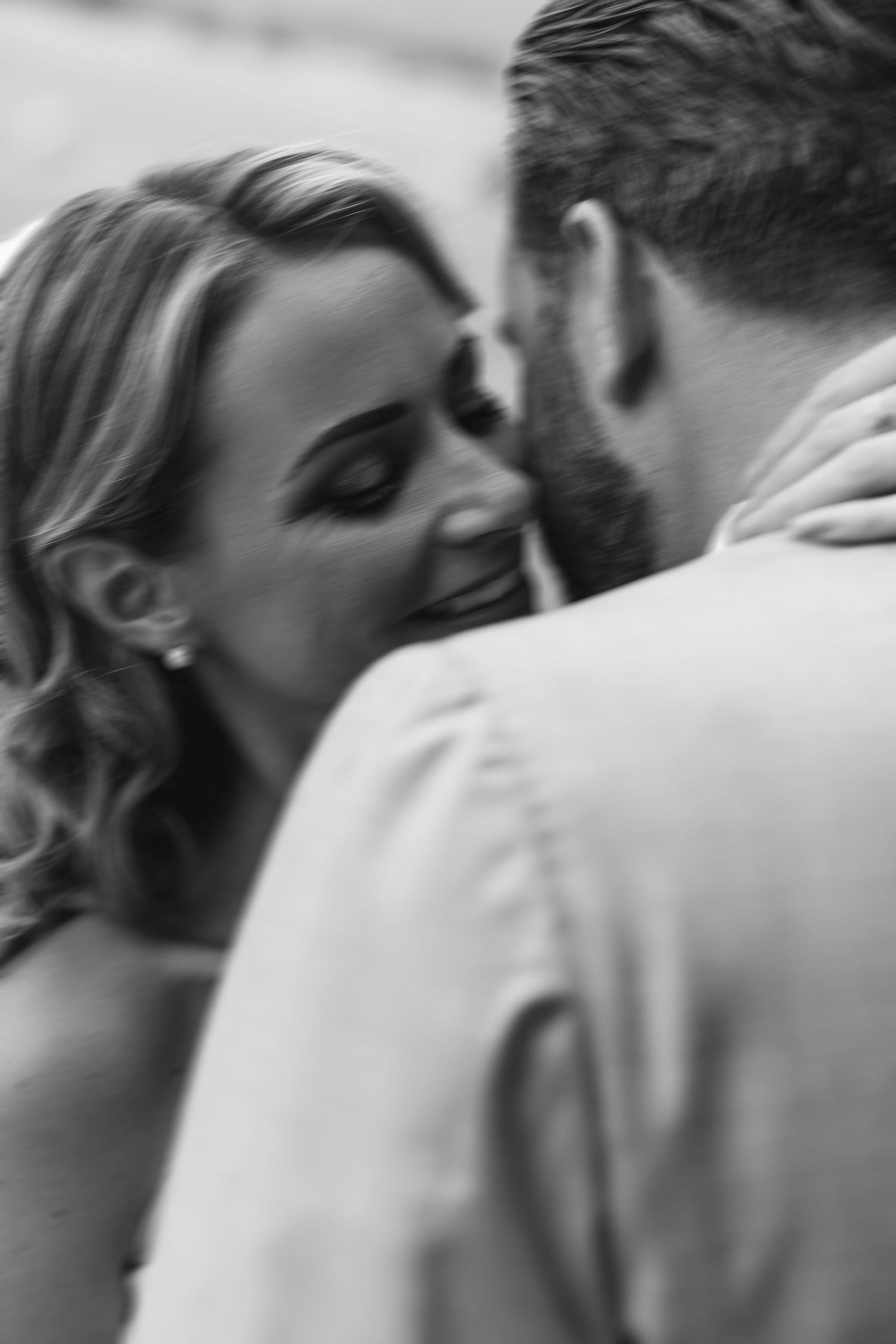 A tender black and white close-up moment between two people.