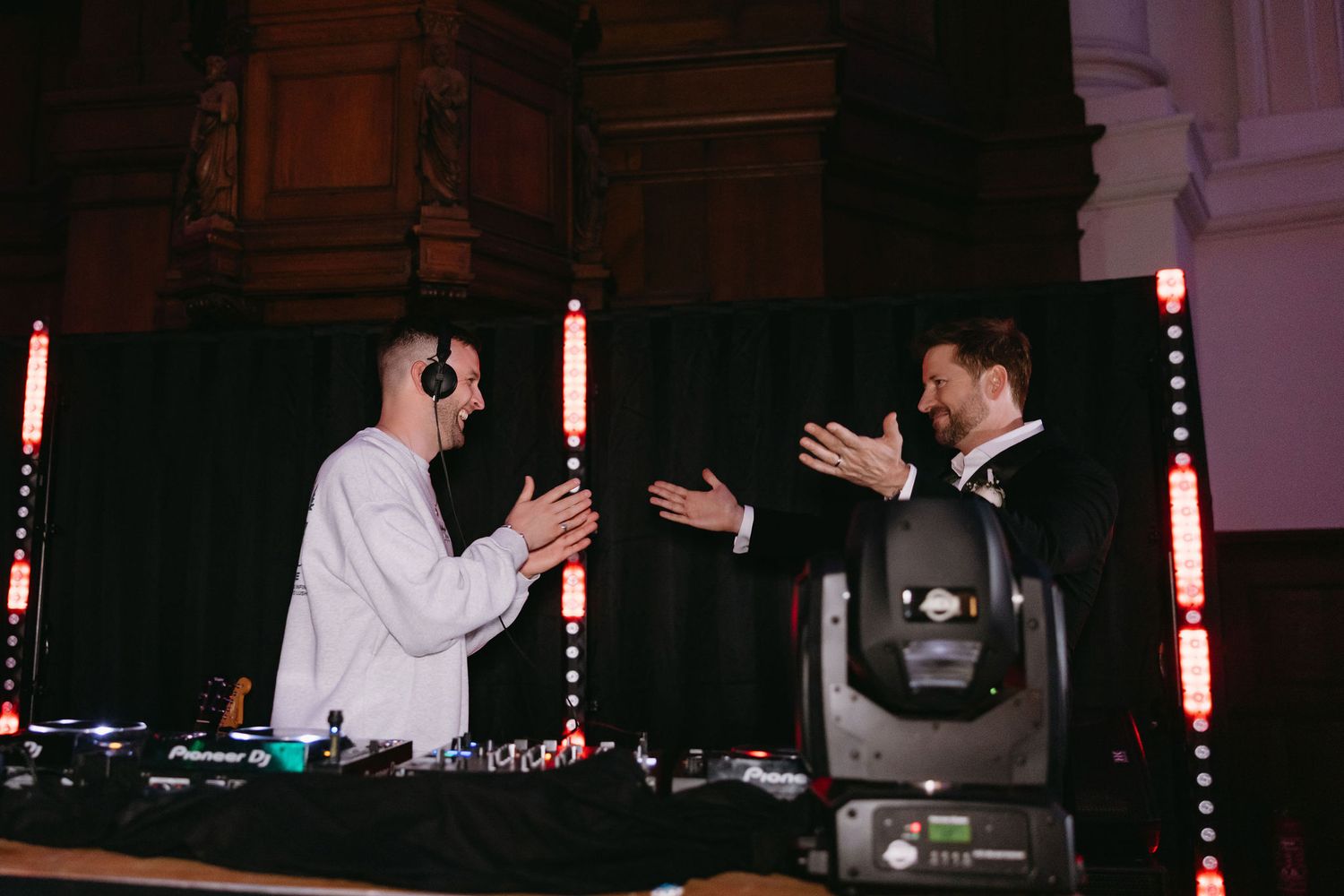 DJ equipment setup with glowing red lights at wedding reception venue.