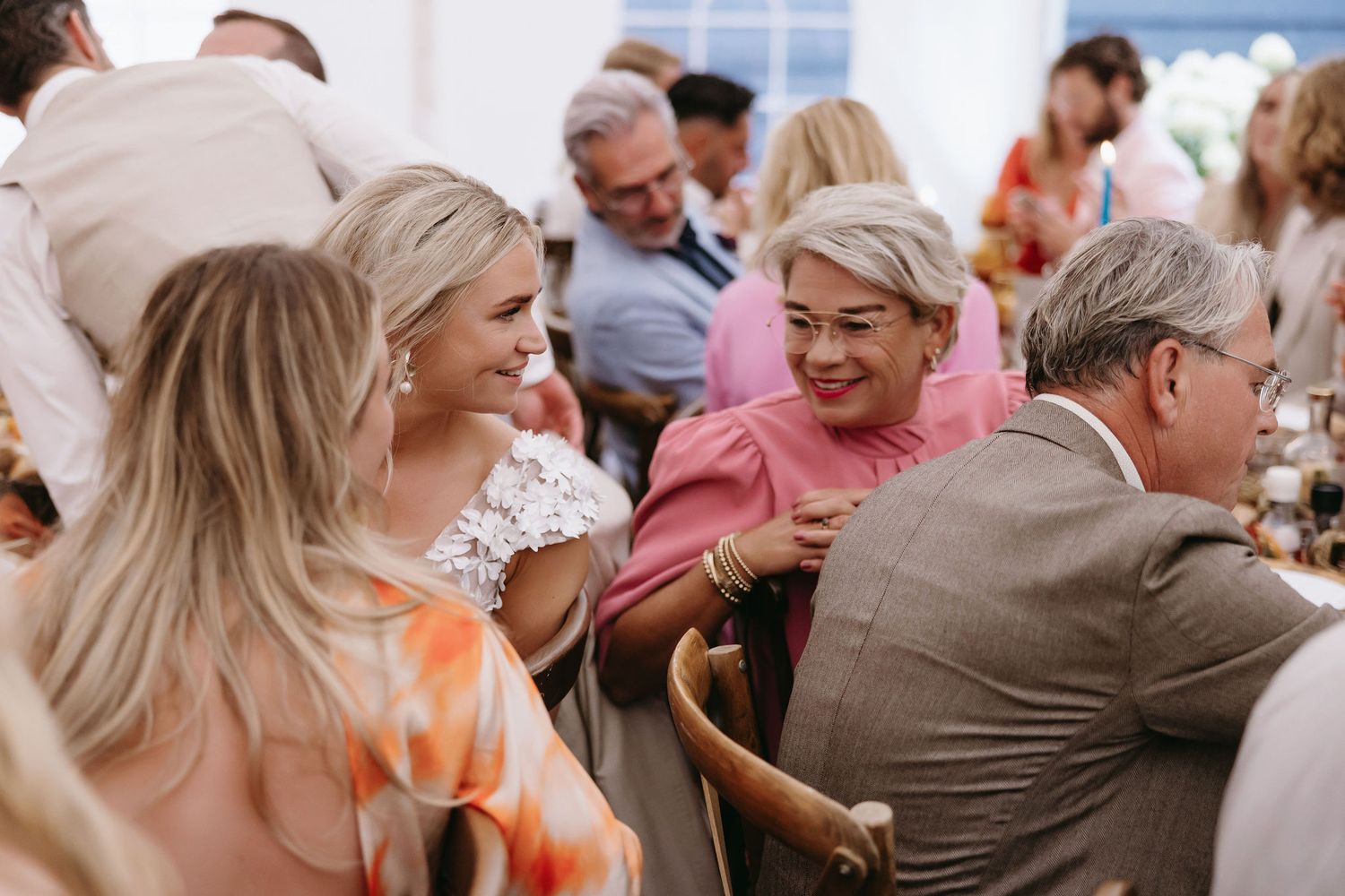 Candid moments of wedding guests celebrating at an outdoor reception.