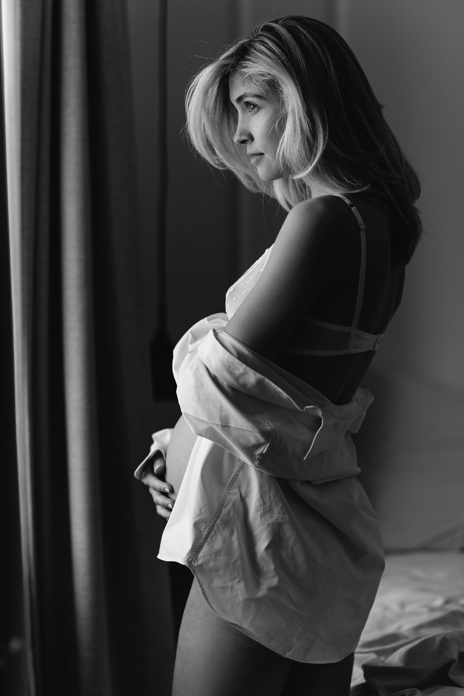 Moody black and white portraits capturing intimate moments in soft window light.