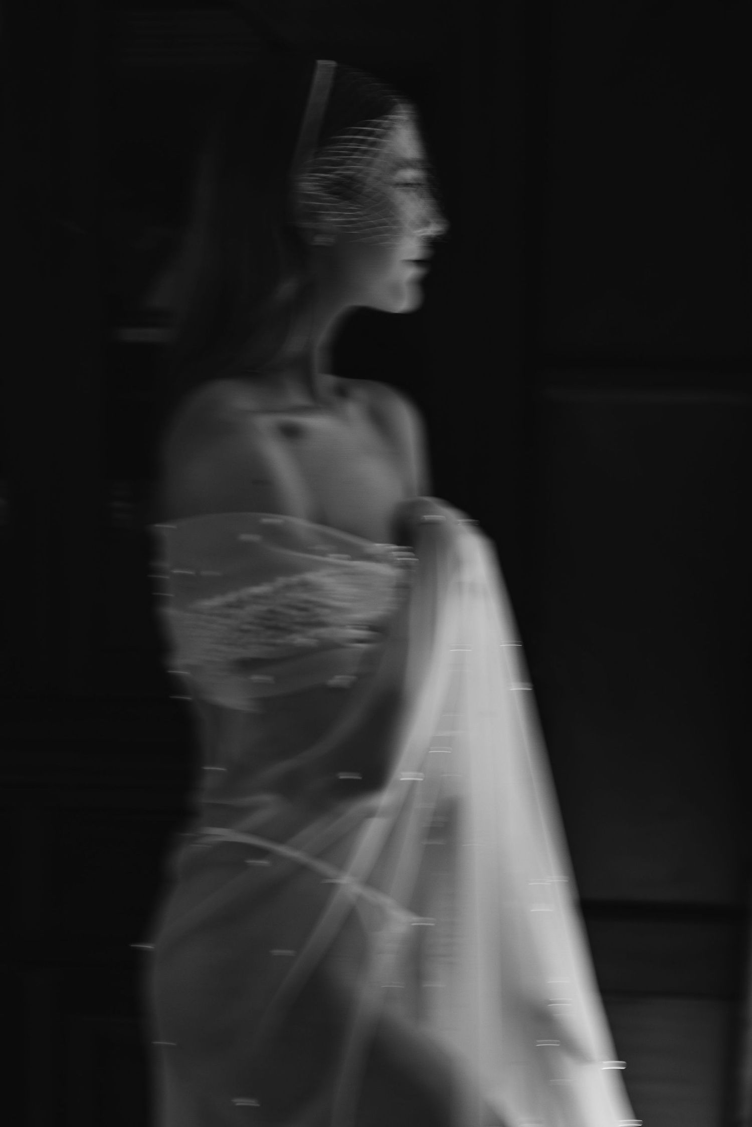 A series of ghostly motion blur photographs showing an ethereal figure in white moving through darkness.