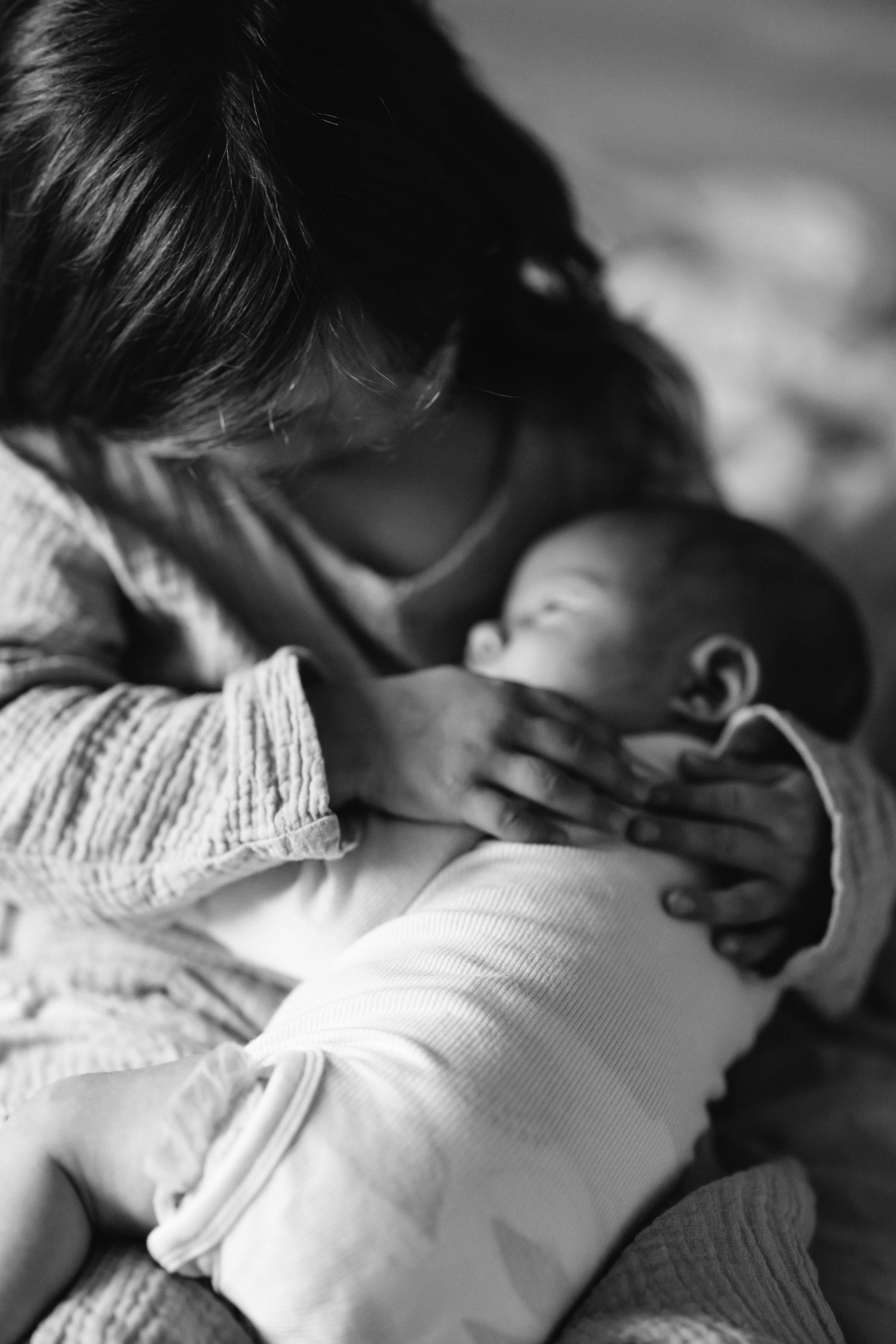Close-up black and white sequence showing gentle embraces and soft textures.