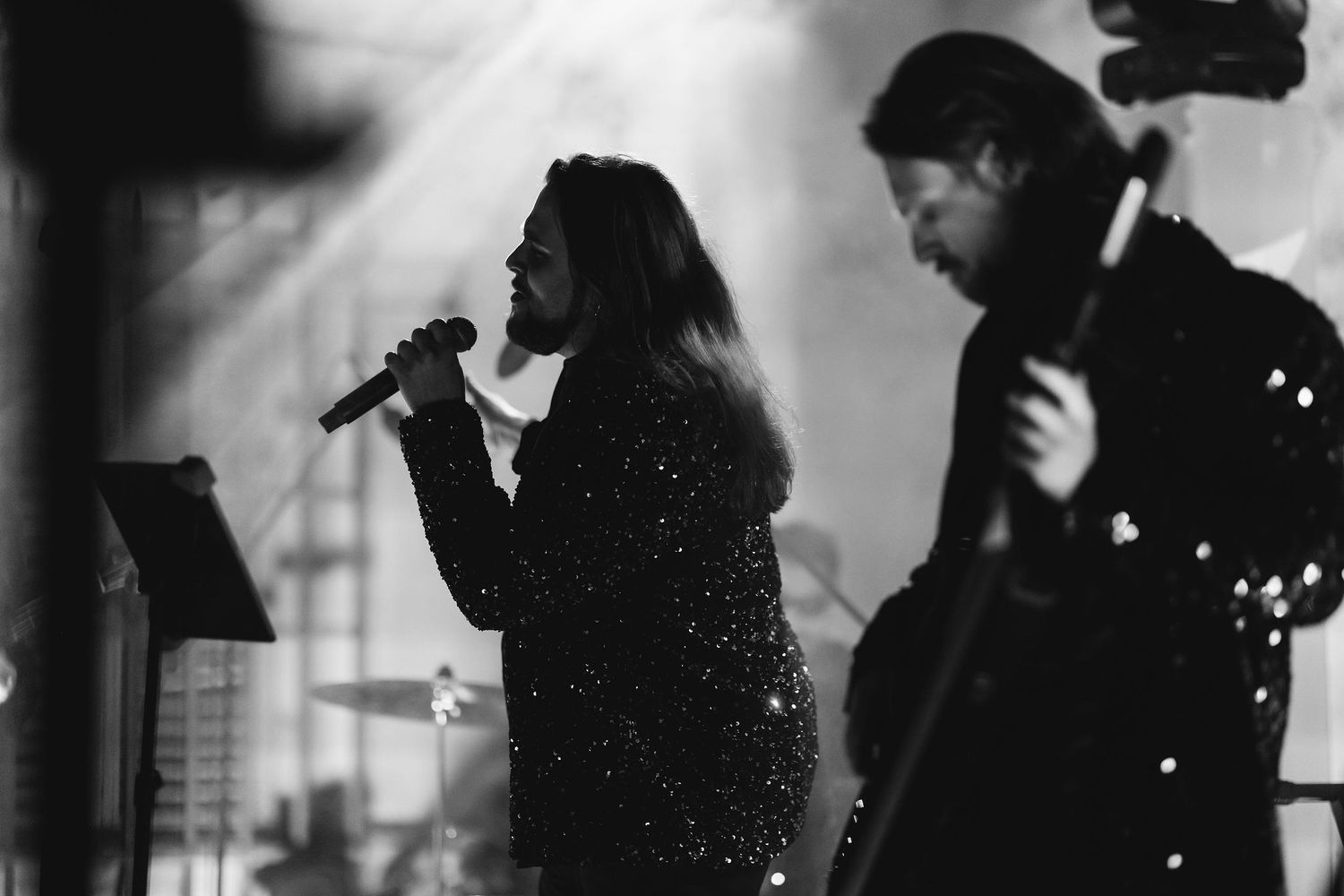 Silhouettes of musicians performing at an evening wedding reception.