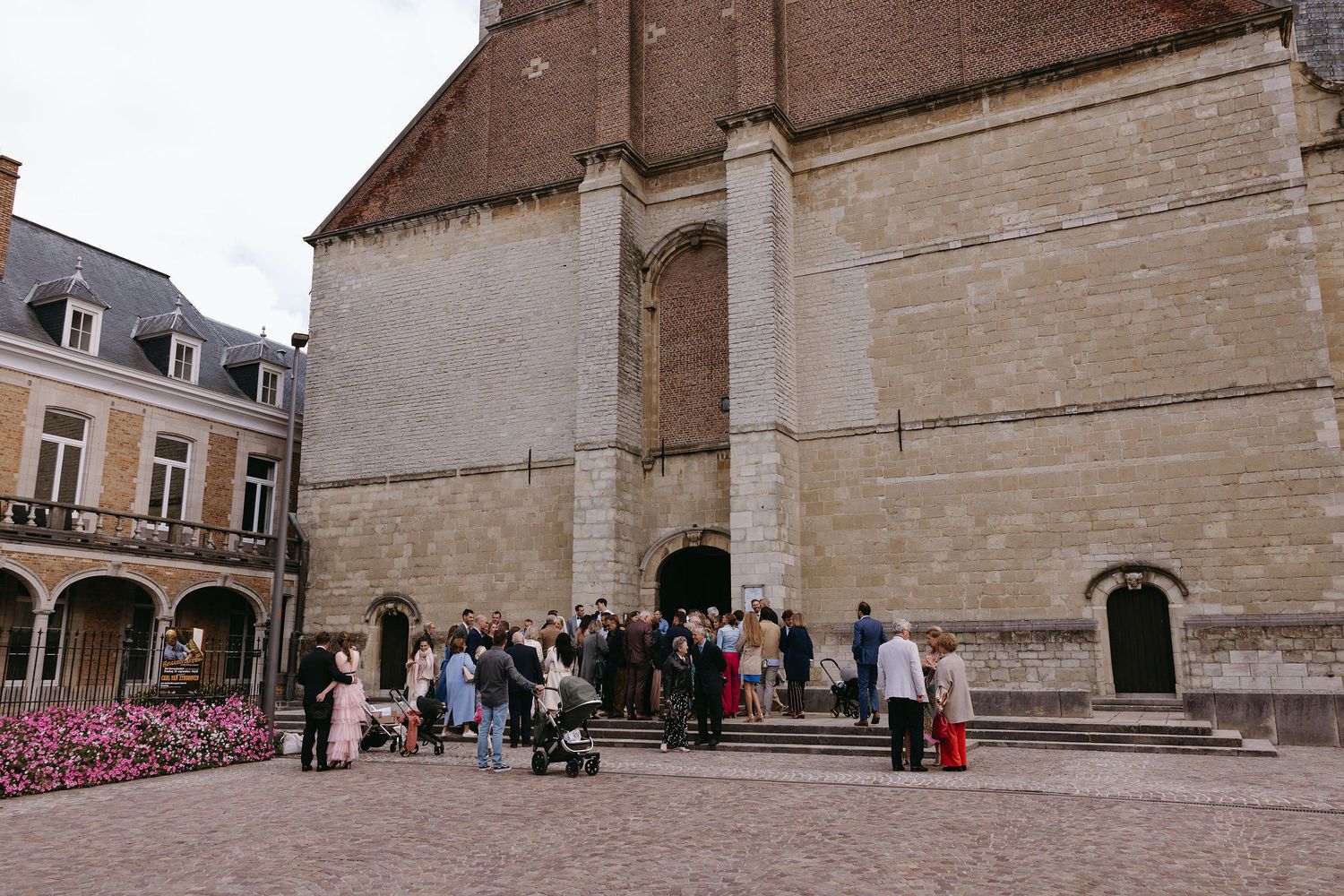 Panoramic exterior view of a historic stone church building and courtyard.